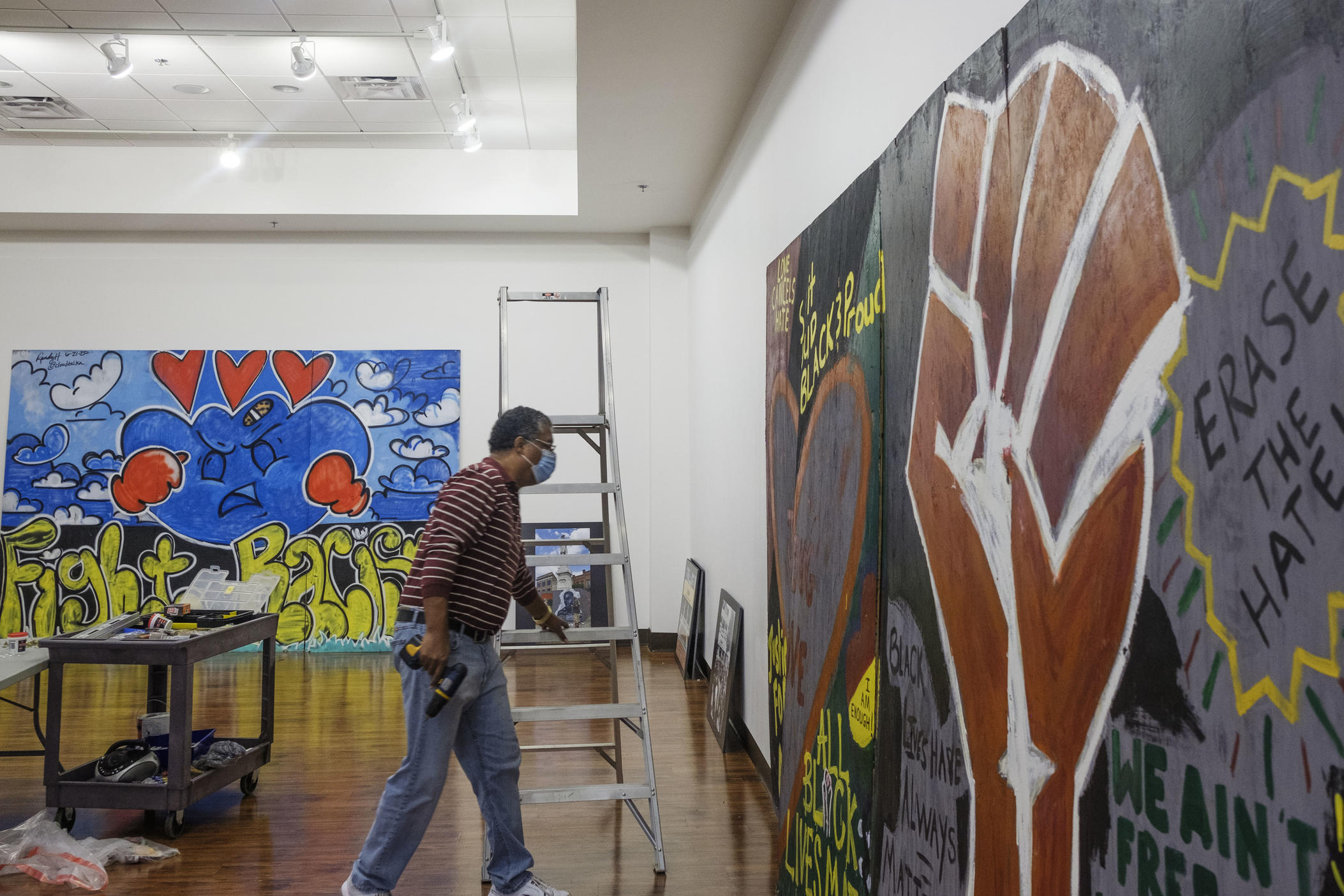 Tubman African American Museum curator Jeff Bruce mounting art made during civil rights activism in Macon in 2020 for a new exhibit at the museum. 