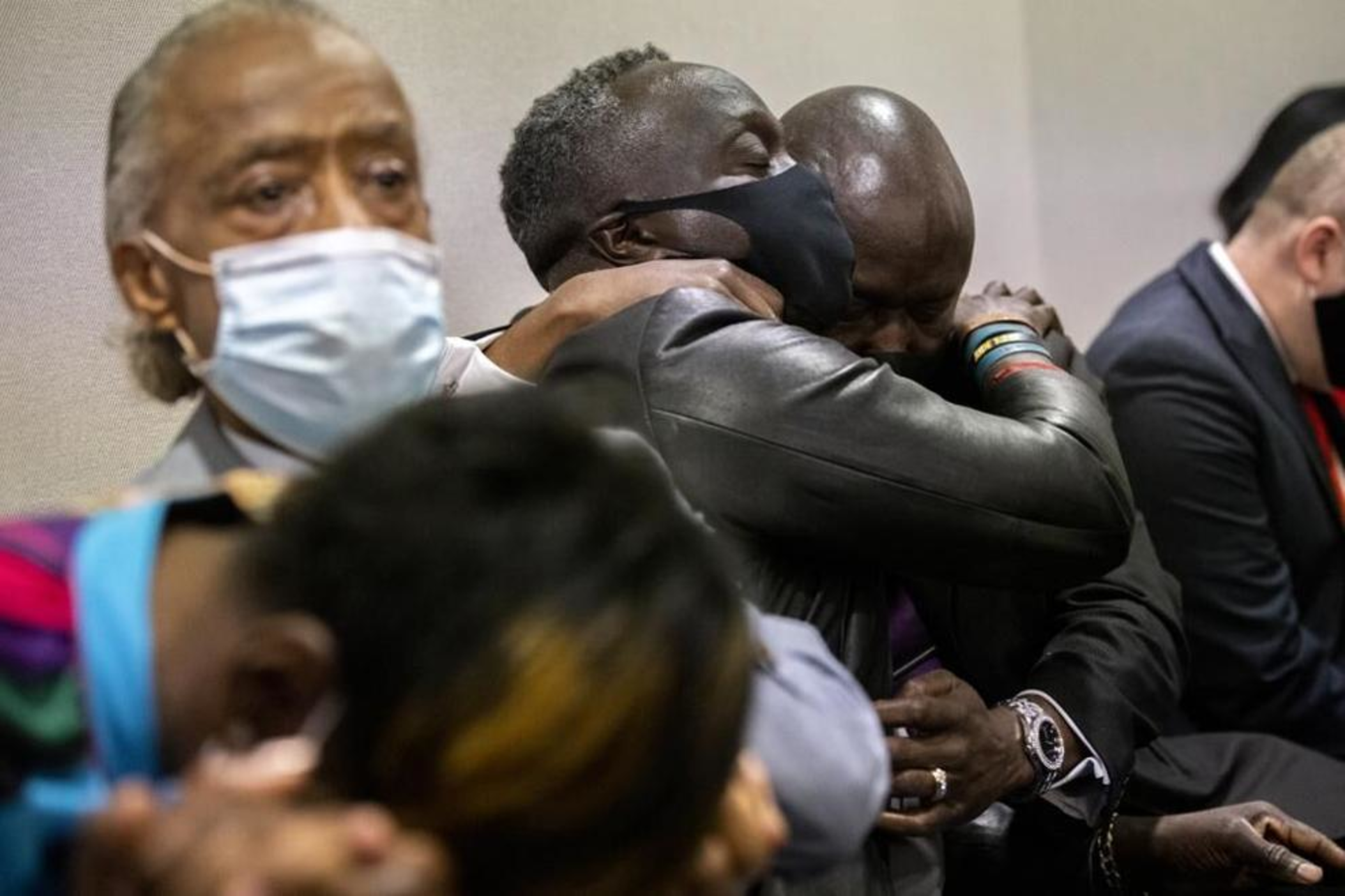 Ahmaud Arbery's father Marcus Arbery, center, is hugged by his attorney Benjamin Crump after the jury convicted Travis McMichael in the Glynn County Courthouse, Wednesday, Nov. 24, 2021, in Brunswick, Ga. Greg McMichael and his son, Travis McMichael, and a neighbor, William "Roddie" Bryan, charged in the death of Ahmaud Arbery were convicted of murder Wednesday in the fatal shooting that became part of a larger national reckoning on racial injustice.