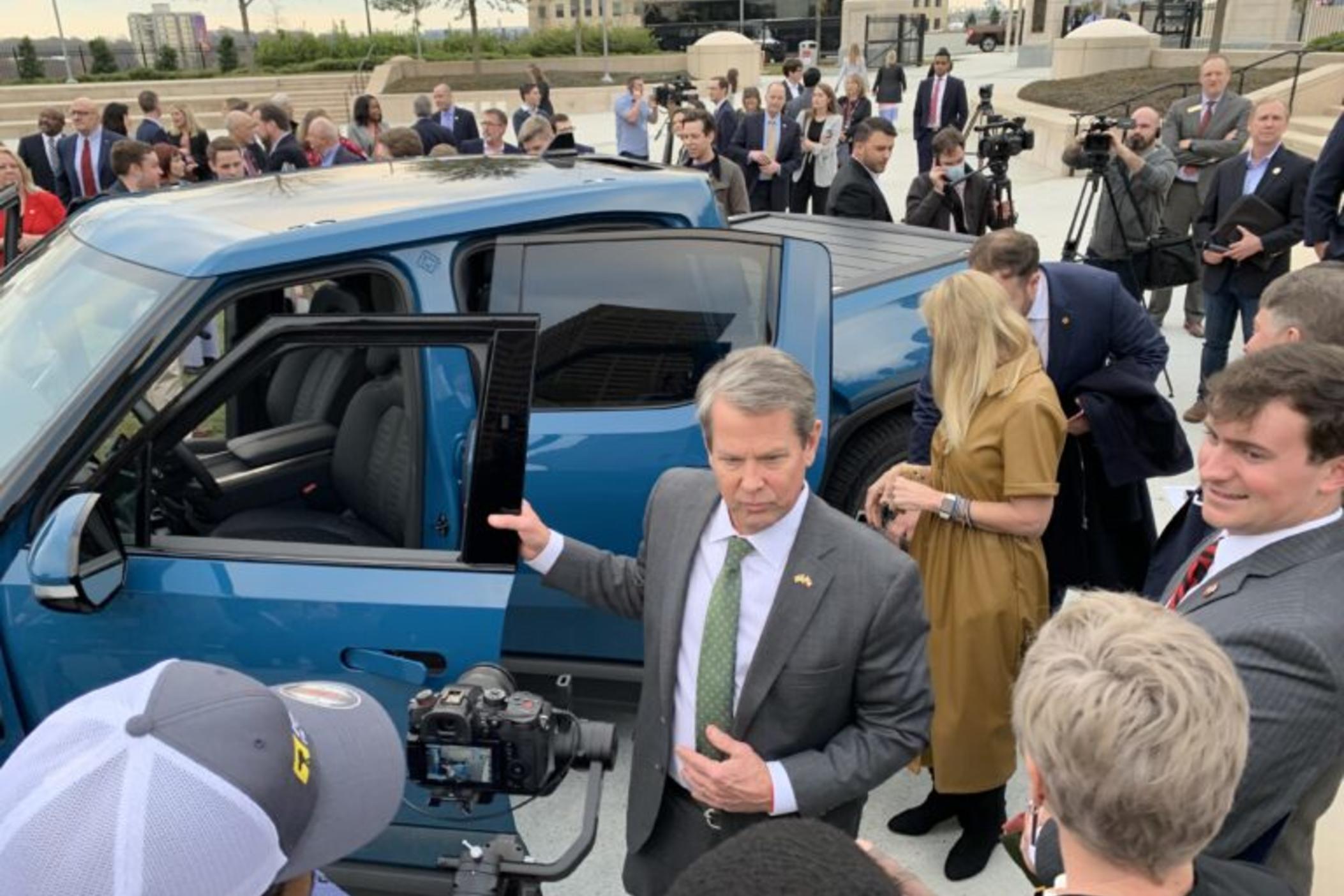  Gov. Brian Kemp steps out of a Rivian truck Thursday at a press event announcing the the electric vehicle maker will build a factory in Georgia. Jill Nolin/Georgia Recorder