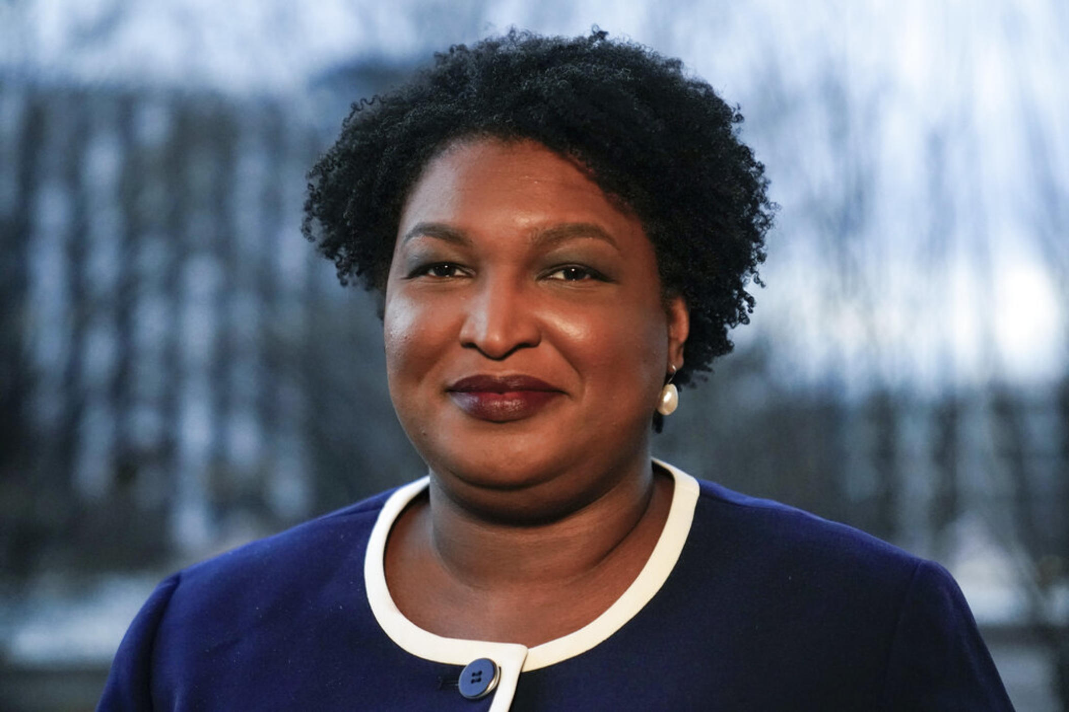 Georgia gubernatorial Democratic candidate Stacey Abrams poses for a photo during an interview with The Associated Press on Dec. 16, 2021, in Decatur, Ga. Abrams was missing Tuesday when President Joe Biden swung through the city to press for voting rights protections. 