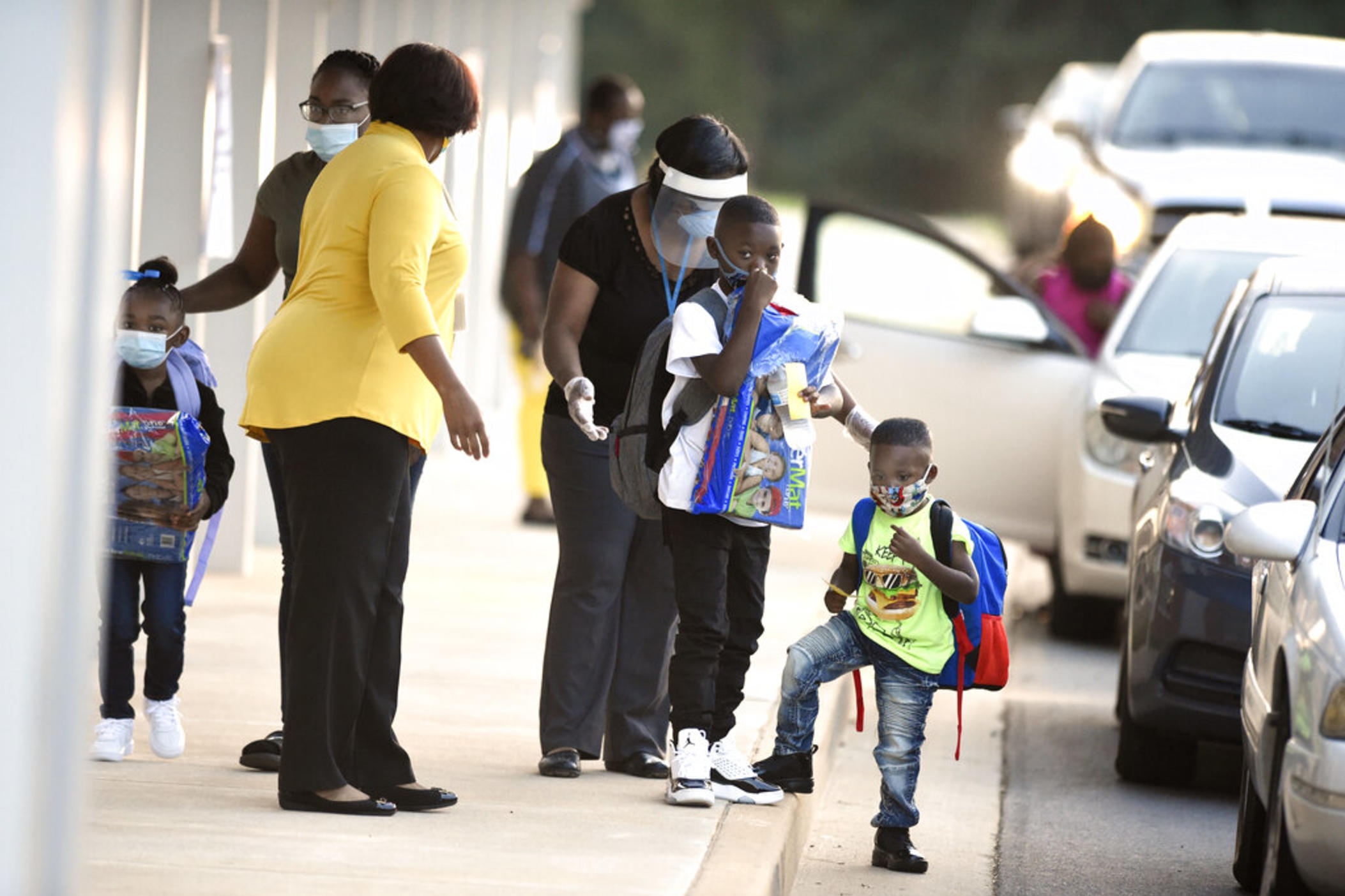 Children get dropped off at a car line as they head back to class for the first day of school at Wheeless Road Elementary School Tuesday, Sept. 8, 2020, in Augusta, Ga.