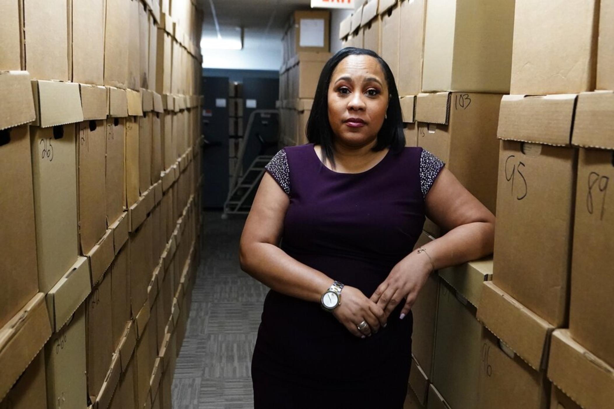 Fulton County District Attorney Fani Willis poses for a photo at her office, Feb. 24, 2021 in Atlanta. The Georgia prosecutor who’s investigating possible attempts to interfere in the 2020 general election by former President Donald Trump and others has asked for a special grand jury to aid the investigation. Willis, on Thursday, Jan. 20, 2022, sent a letter to Fulton County Superior Court Chief Judge Christopher Brasher asking him to impanel a special grand jury.