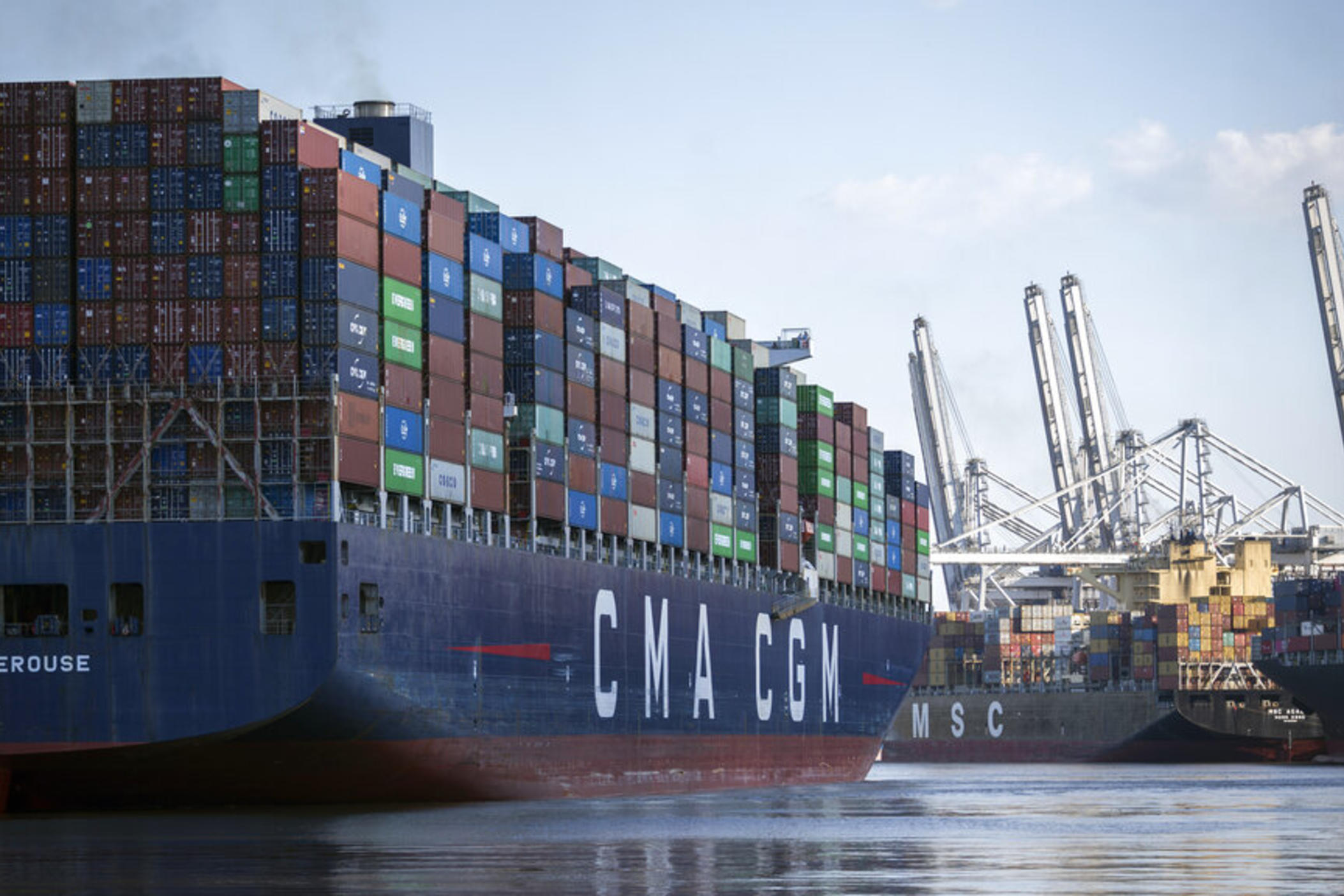 The container ship CMA CGM Laperouse, left, docks at the Georgia Ports Authority's Port of Savannah, Sept. 29, 2021, in Savannah, Ga. The Port of Savannah saw a whopping 20% increase in shipping containers moving across its docks in 2021 as U.S. seaports scrambled to keep up with a surge in cargo that crammed container yards and forced ships to line up and wait at sea.