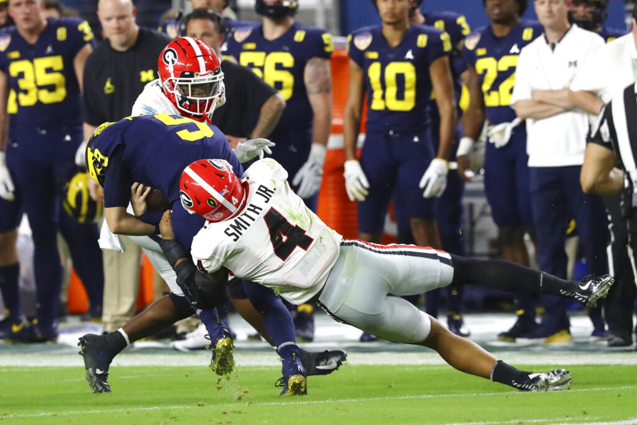 Georgia linebacker Nolan Smith (4) tackles Michigan quarterback J.J. McCarthy (9) during the second quarter of the NCAA College Football Playoff Orange Bowl game Friday, Dec. 31, 2021, in Miami Gardens, Fla. Georgia will play Alabama in an all-Southeastern Conference College Football Playoff national championship on Monday, Jan. 10, 2022.