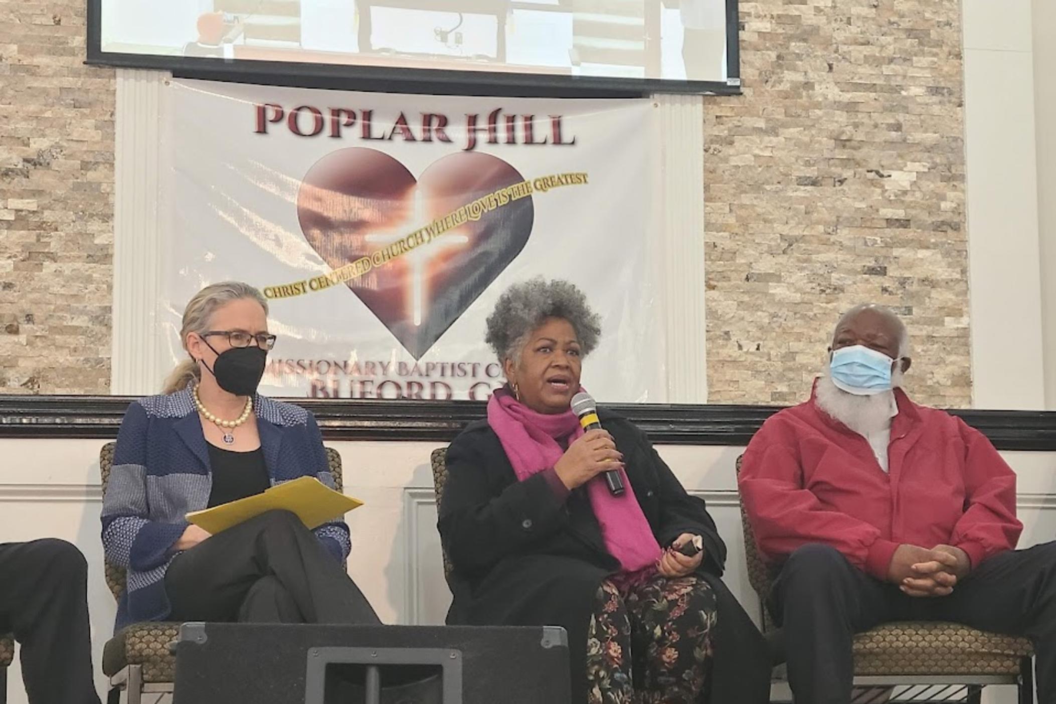 Elon Butts Osby, a direct descendant of victims of the 1912 Forsyth County Racial Cleansing, speaks on a panel about the historic event with Congresswoman Carolyn Bourdeaux and James B Knuckles another descendent.