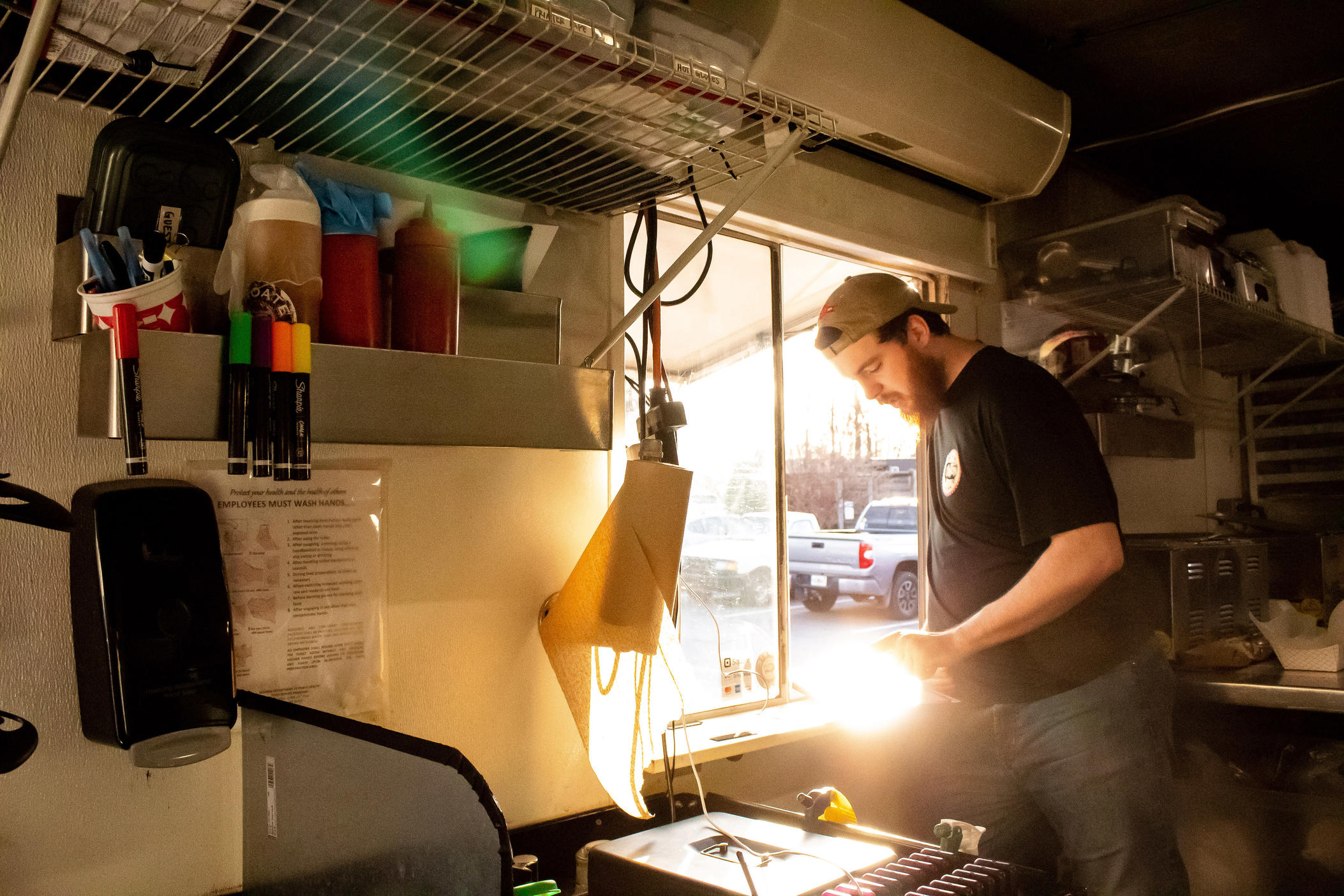Levi Brock takes a customer's order inside the Choate BBQ food truck in Woodstock, Georgia on Feb. 16.