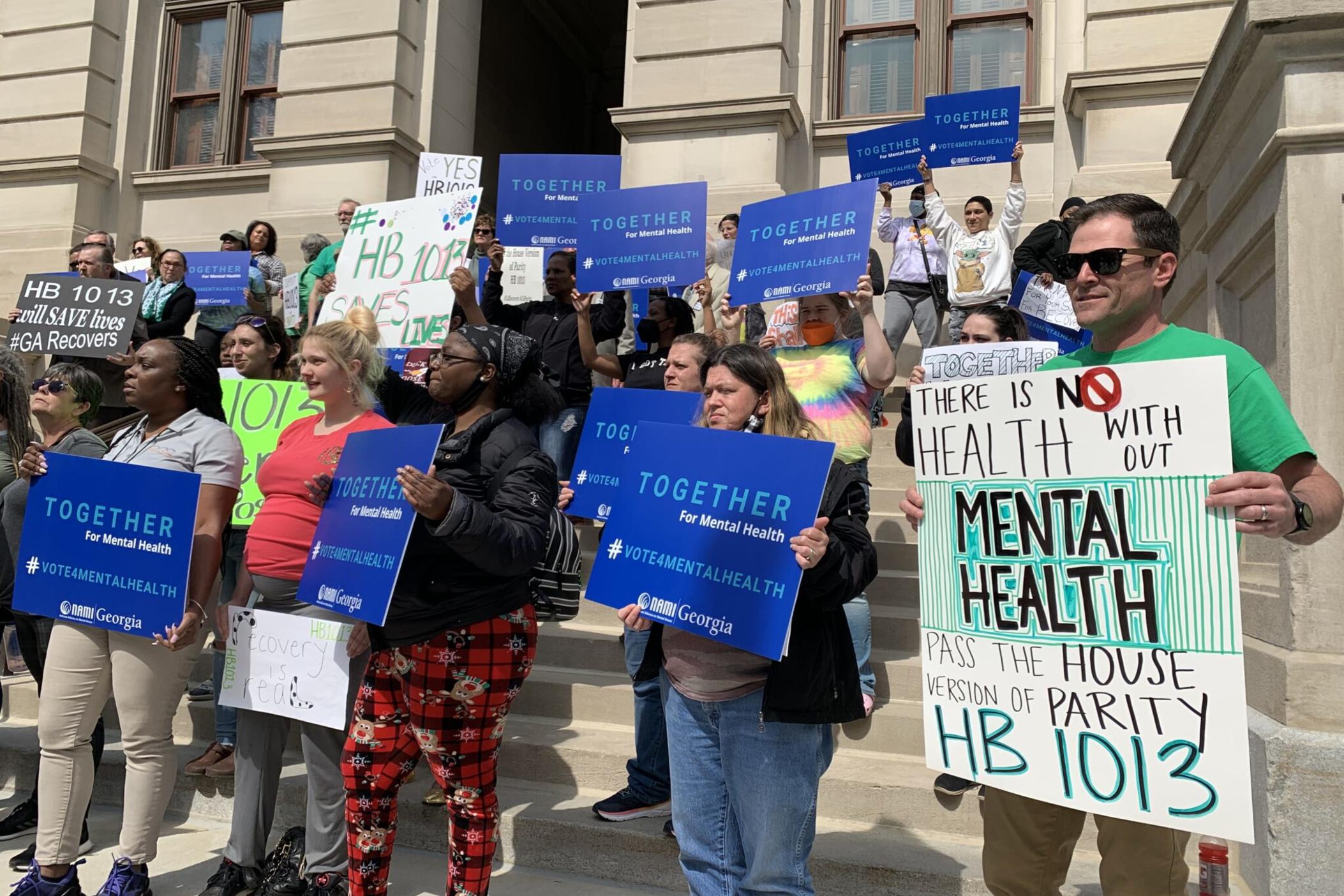Demonstrators rally at the Georgia Capitol in support of a mental health parity bill in March 2022.