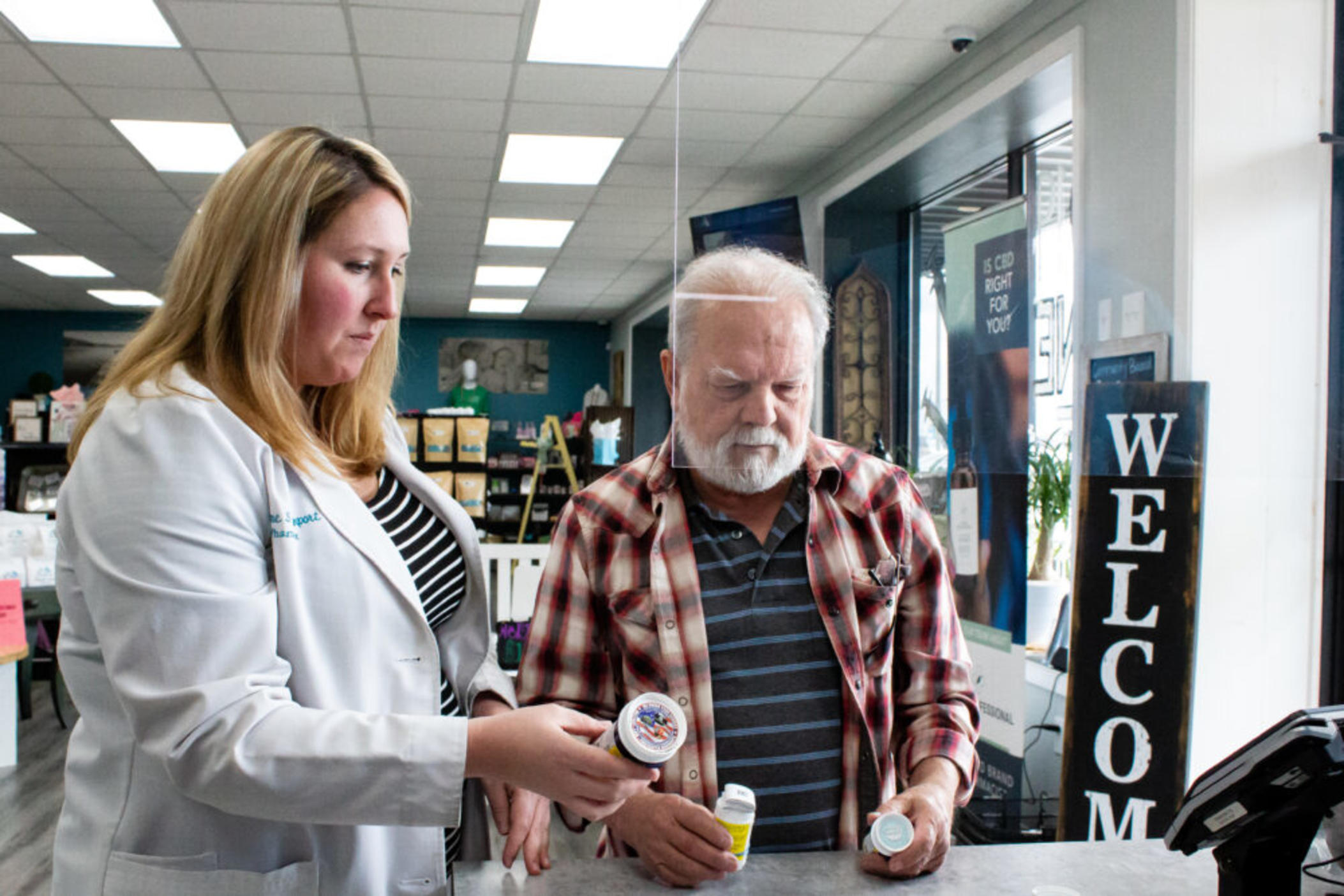 Pharmacist Suzanne Davenport (left) answers a question for patient Mike Britton (right) about his prescription at Southern Drug Company in Blue Ridge, Ga. on March 7.