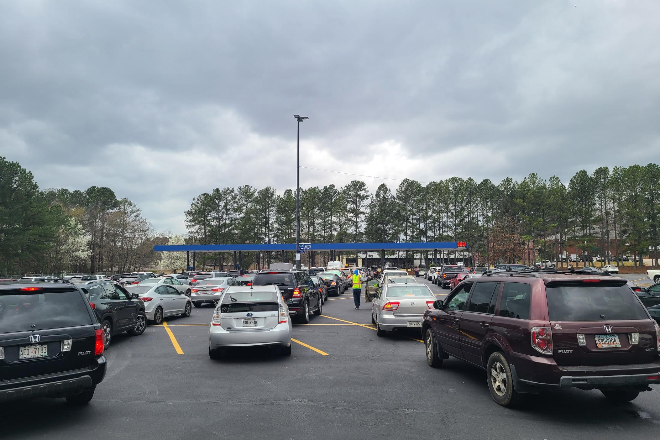Lines of cars fill the parking lot by the gas pumps at Sam's Club in Tucker, Georgia as drivers wait to fill up with the discount gas.