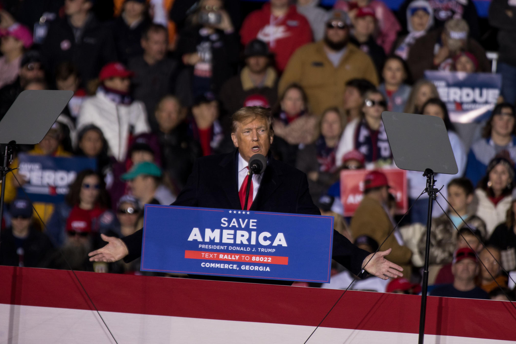 Former President Donald Trump speaks to a crowd of thousands at a Saturday rally for GOP primary candidates in Commerce, Ga., March 26, 2022.