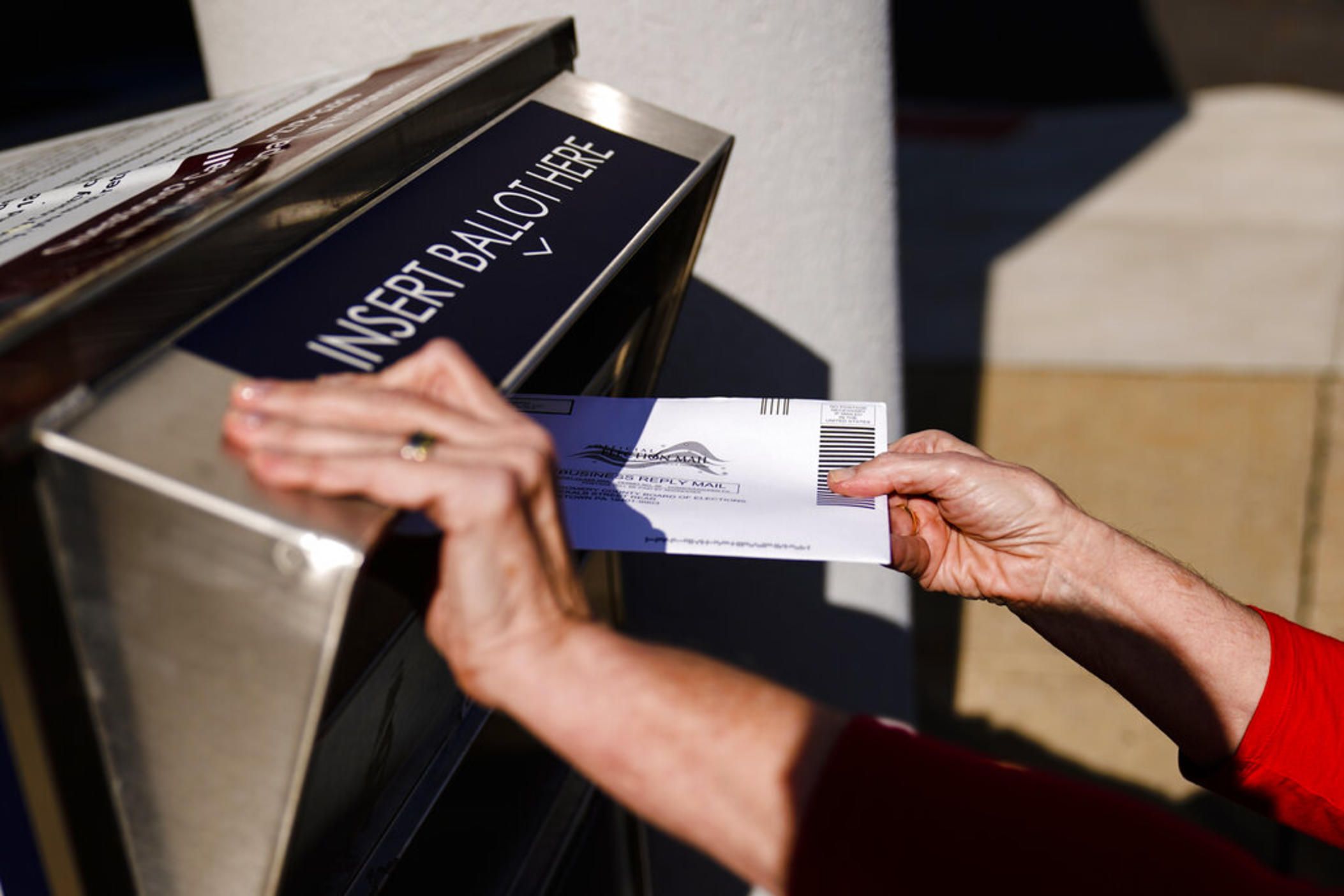 A person drops off a mail-in ballot at an election ballot return box in Willow Grove, Pa., Oct. 25, 2021. On Tuesday, May 3, 2022, The Associated Press reported on a film that used a flawed analysis of cellphone location data and ballot drop box surveillance footage to cast doubt on the results of the 2020 presidential election. 