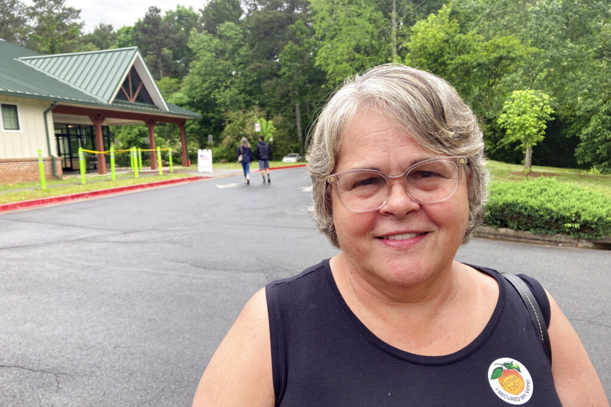 Debbie Hamby, 66, casts a ballot at an early voting site in Acworth, Ga., on Friday, May 6, 2022. Hamby, a nurse from Kennesaw, Georgia, says she believes in-person voting is more secure and supports limits on mail ballots.