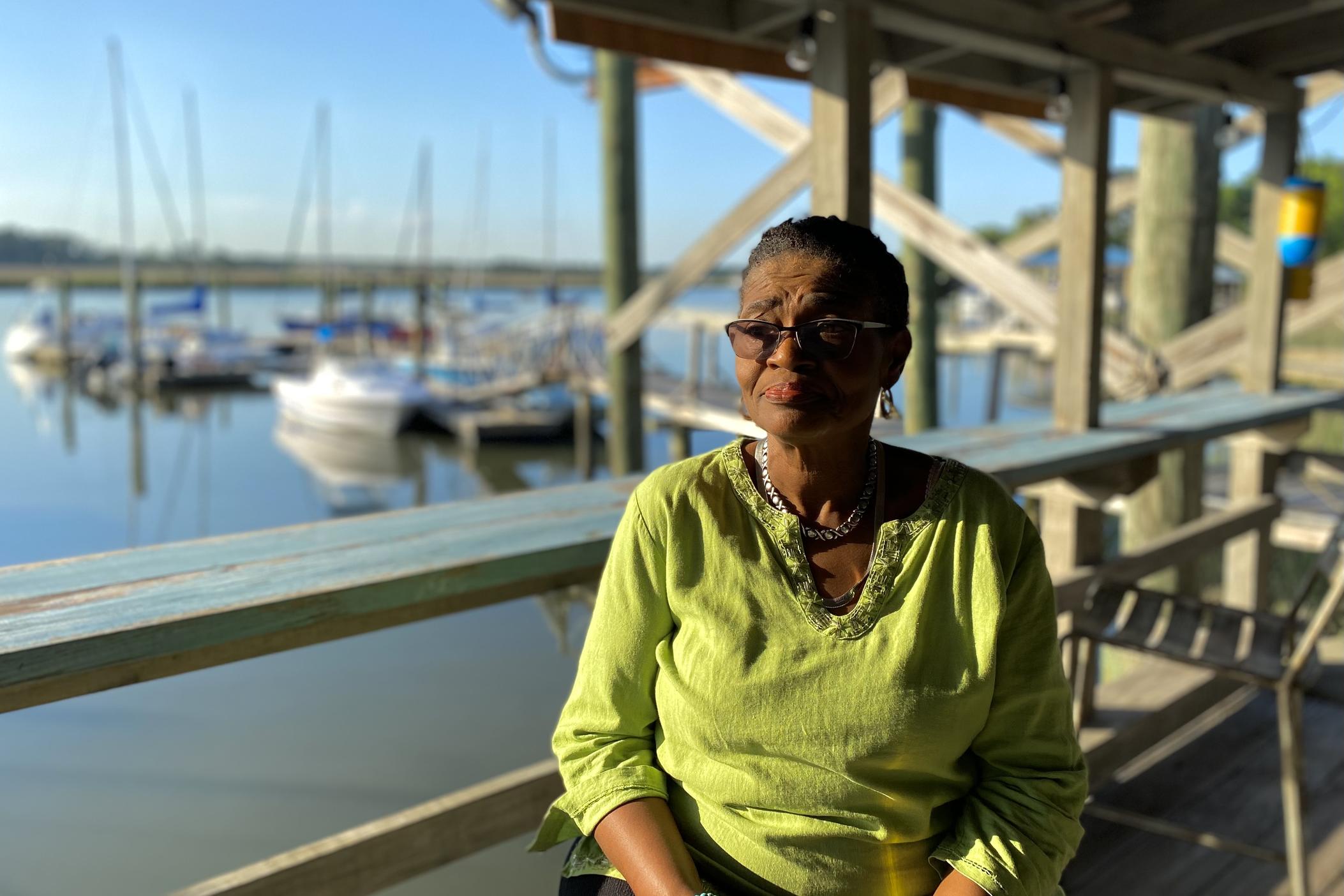 Sarah Suggs, owner of Young's Marina on Wilmington Island, sits on the porch of her dock house.