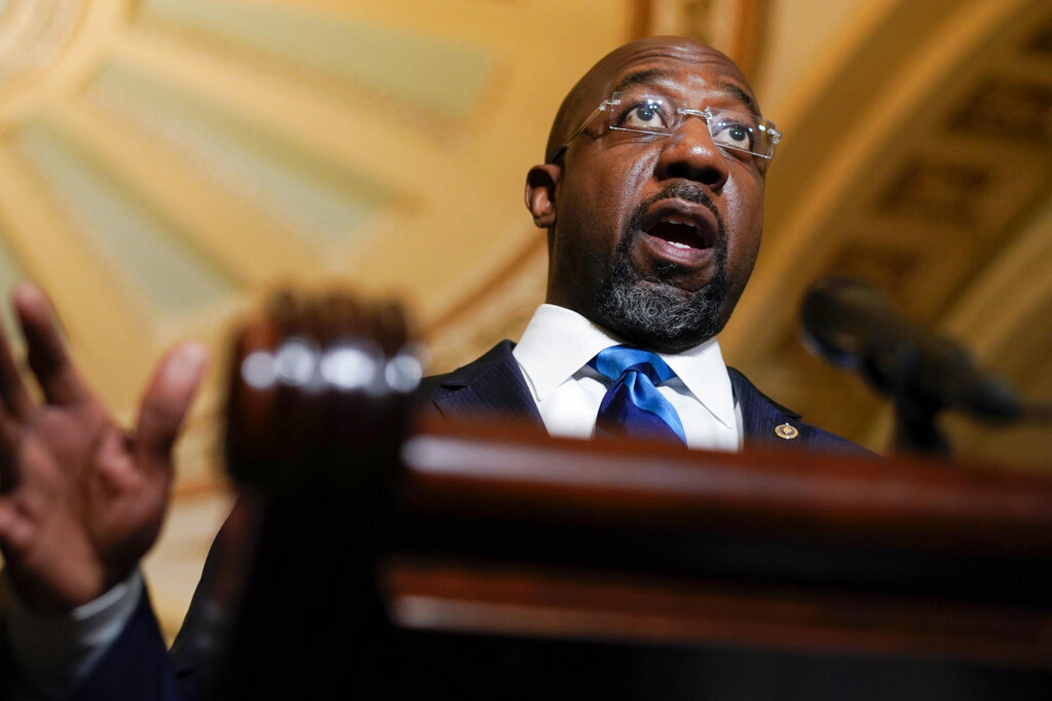 Sen. Raphael Warnock, D-Ga., speaks during a news conference after the weekly Democratic policy luncheon on Capitol Hill in Washington, Tuesday, Dec. 7, 2021. A bipartisan group of Georgia lawmakers is asking congressional budget writers to reject the Biden administration's plan to close a training facility for military pilots.