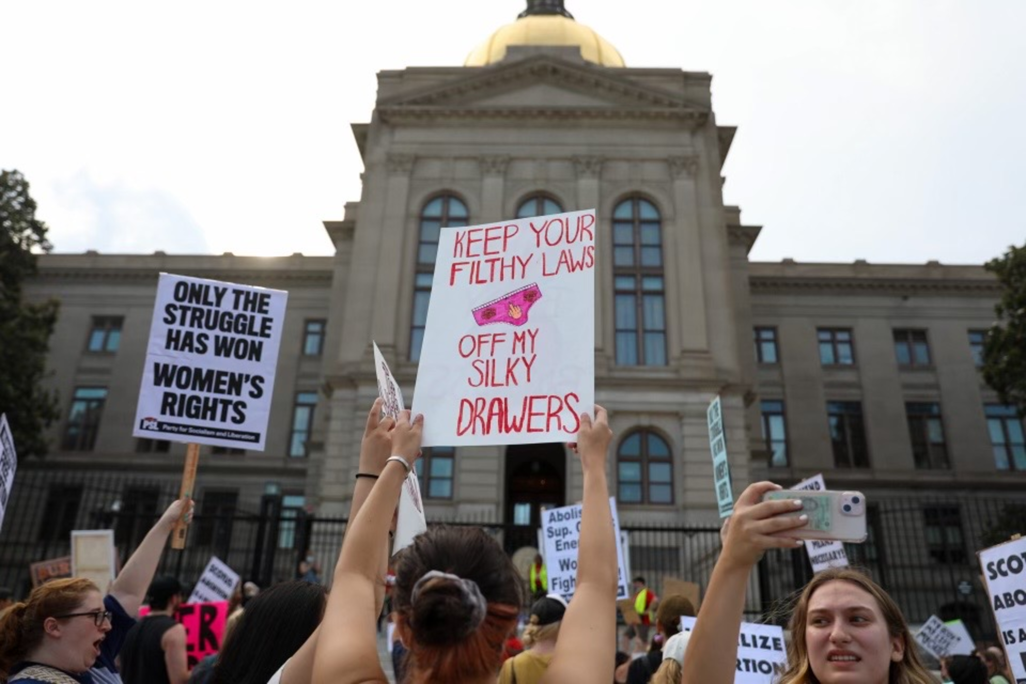 Women protest outside the Georgia State Capitol on Friday June 24, 2022 after the Roe v. Wade decision is announced by the Supreme Court. 