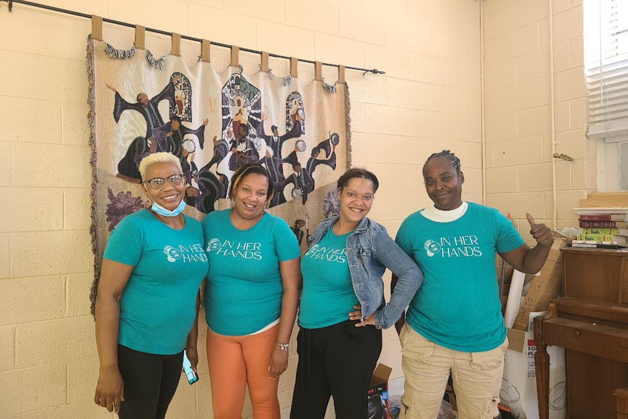 In Her Hands Enrollment Officers Katherine Williams, Tanika Acosta, Kym White, and Lashonda Godfrey educate participants on the resources available to them through the program at enrollment day June 1, 2022.