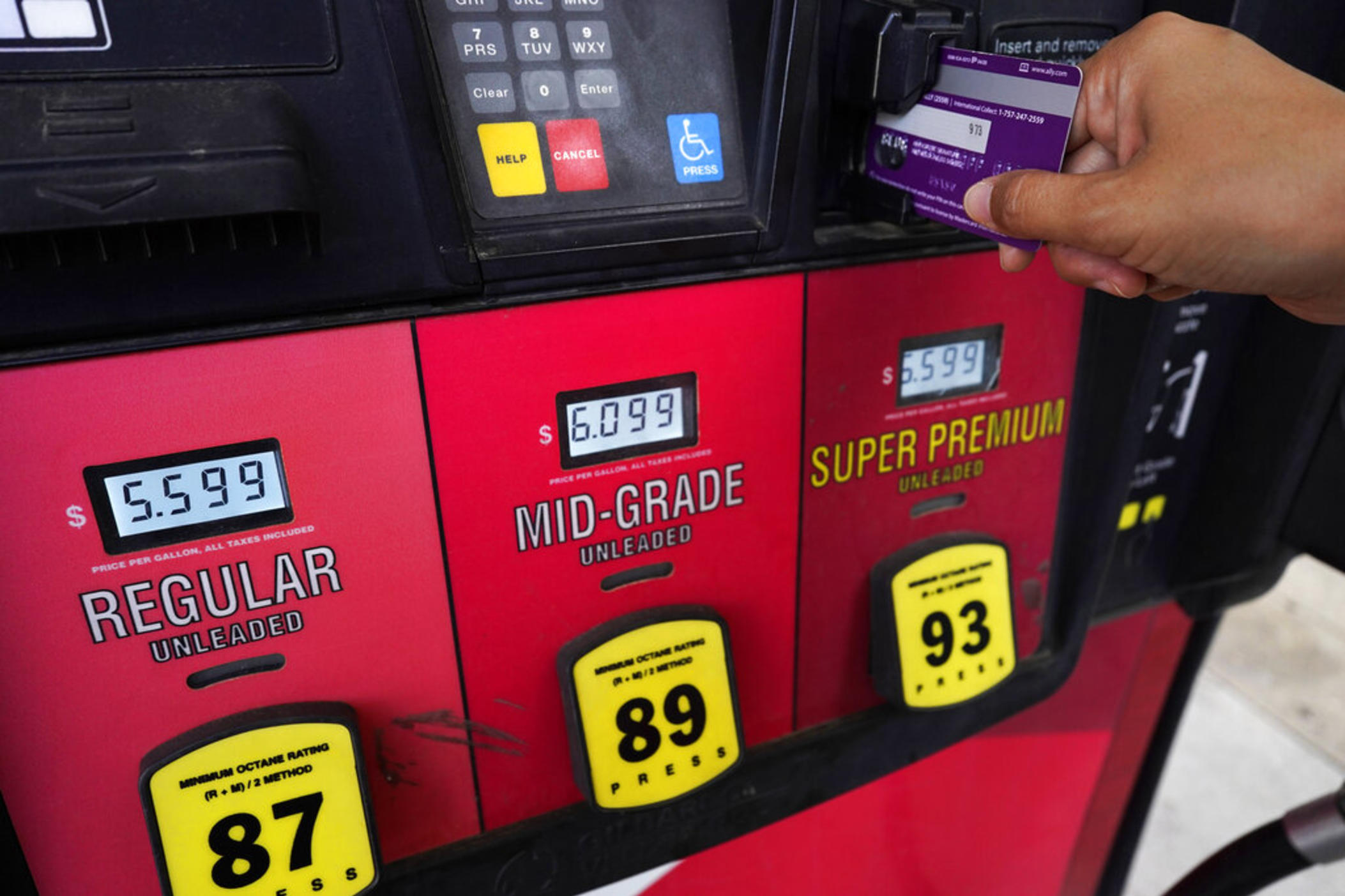 A customer holds a credit card at the pay-at-the-pump gasoline pump in Rolling Meadow, Ill., Thursday, June 30, 2022. U.S consumers have so far defied higher prices for gas, food, and rent and have been spending more in 2022, providing crucial support to the economy. The Wall Street Journal reports that Visa and Mastercard have raised the amount a gas station can hold up to $175 on credit or debit card at the pump. 