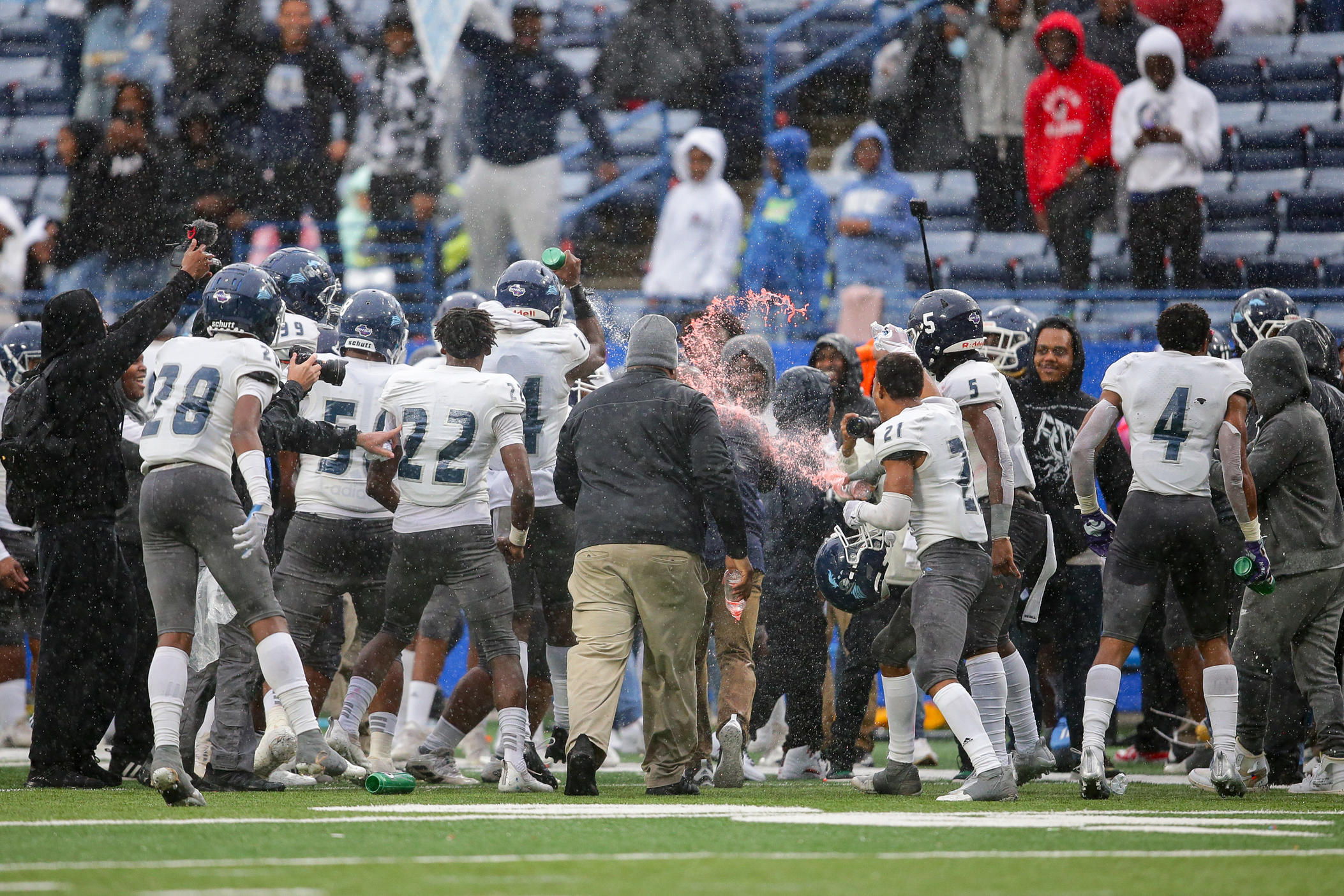 Cedar Grove head coach John Adams getting a Gatorade bath following the Saints 2021 3A State Championship victory.