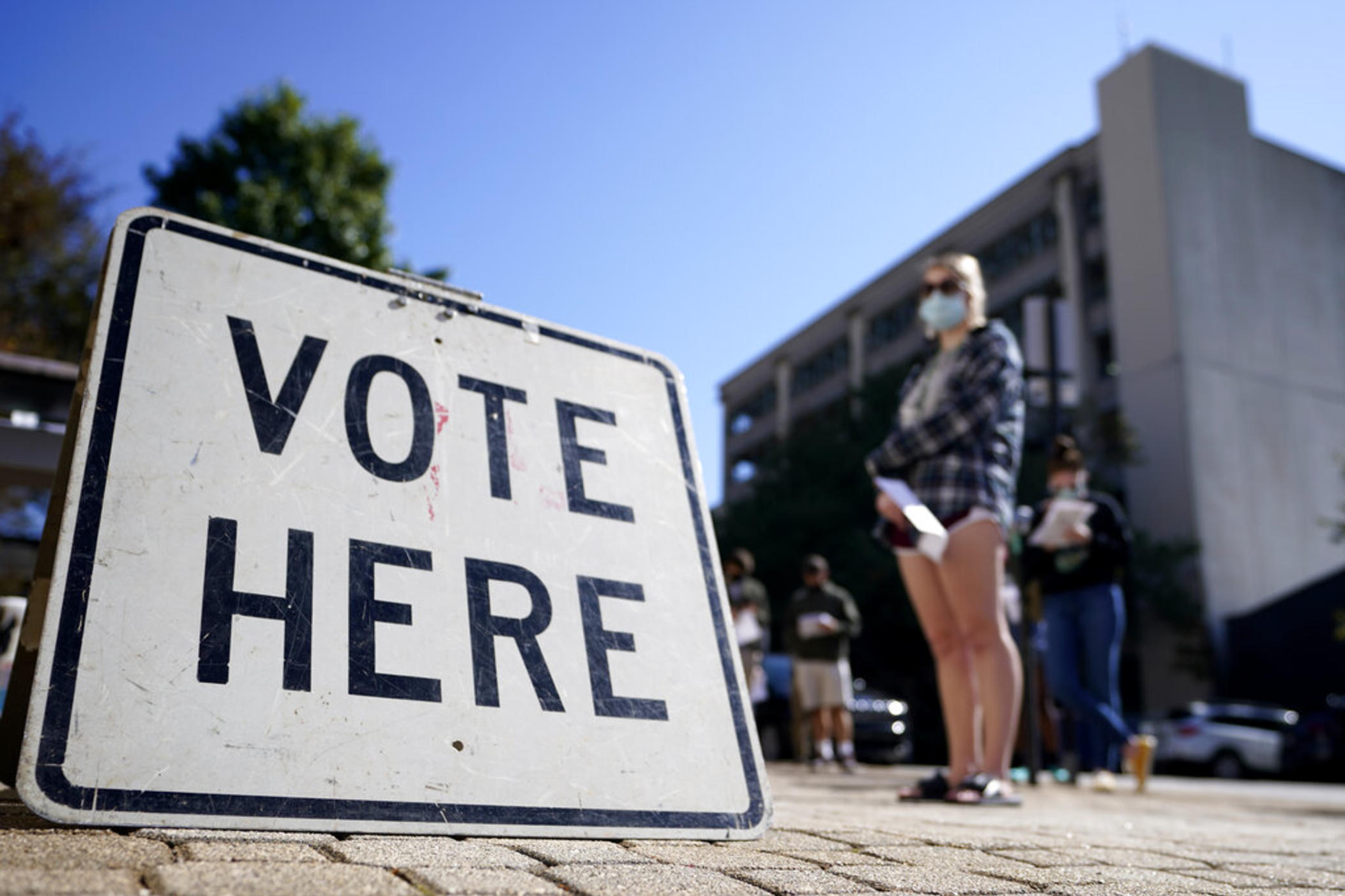 Voters stand in a line as they wait to vote early on Oct. 19, 2020, in Athens, Ga. Lawyers on Monday, July 18, 2022, asked a federal judge to block Georgia's 2021 ban on giving gifts including food and water to voters waiting in line.