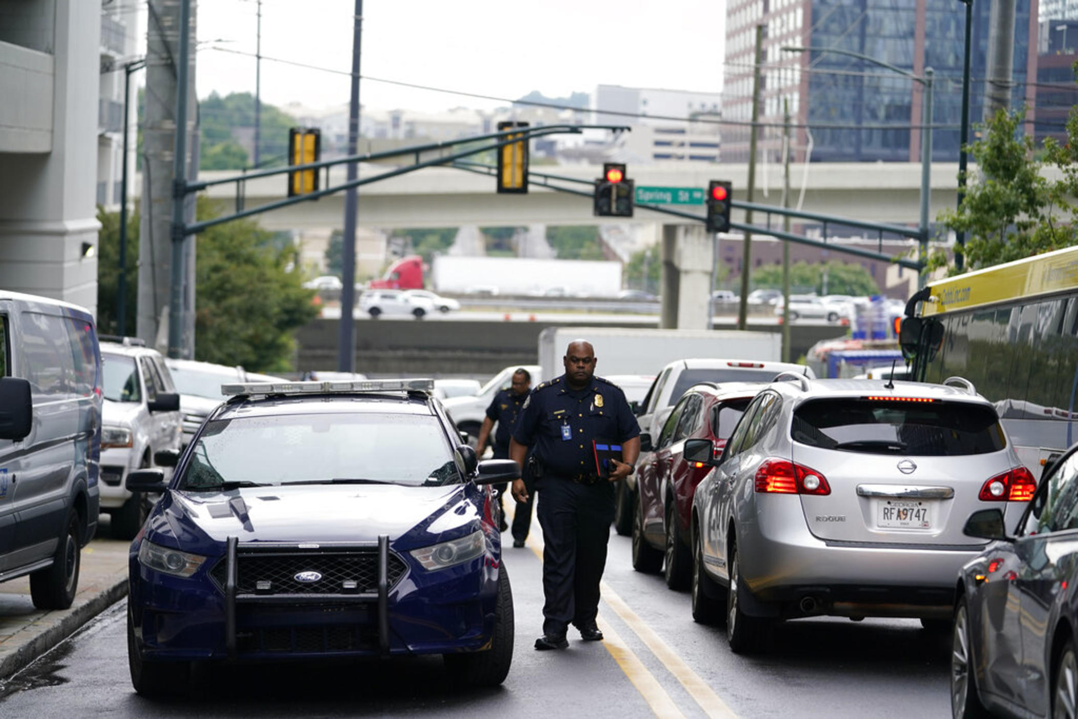 A police officer arrives on scene where a shooting occurred, Monday, Aug. 22, 2022, at a condominium in Atlanta. 