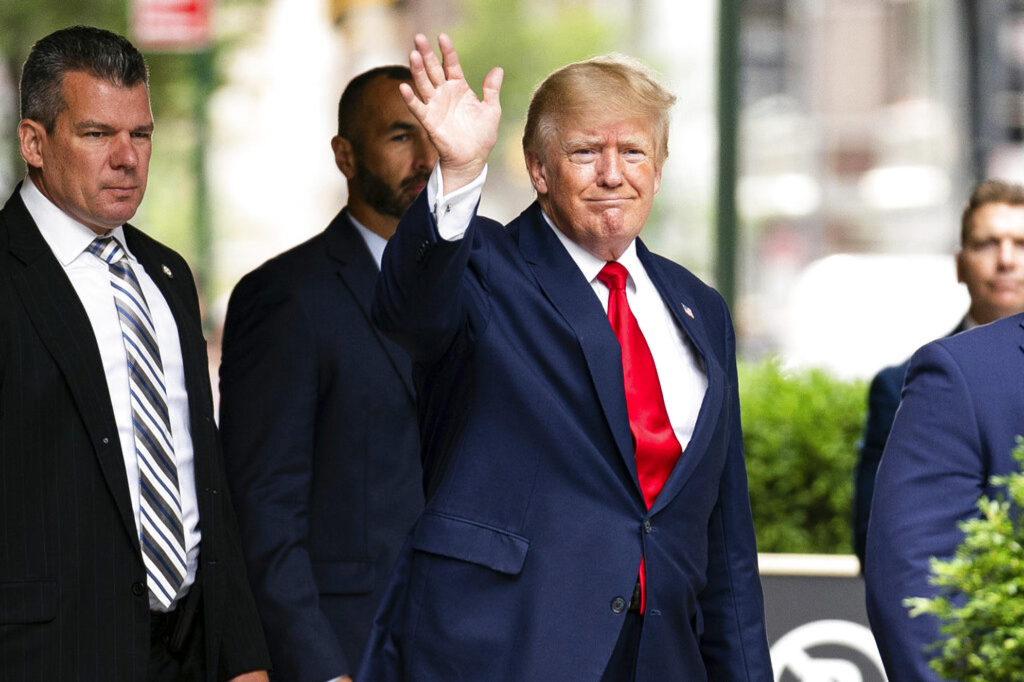 Former President Donald Trump waves as he departs Trump Tower, Wednesday, Aug. 10, 2022, in New York, on his way to the New York attorney general's office for a deposition in a civil investigation.
