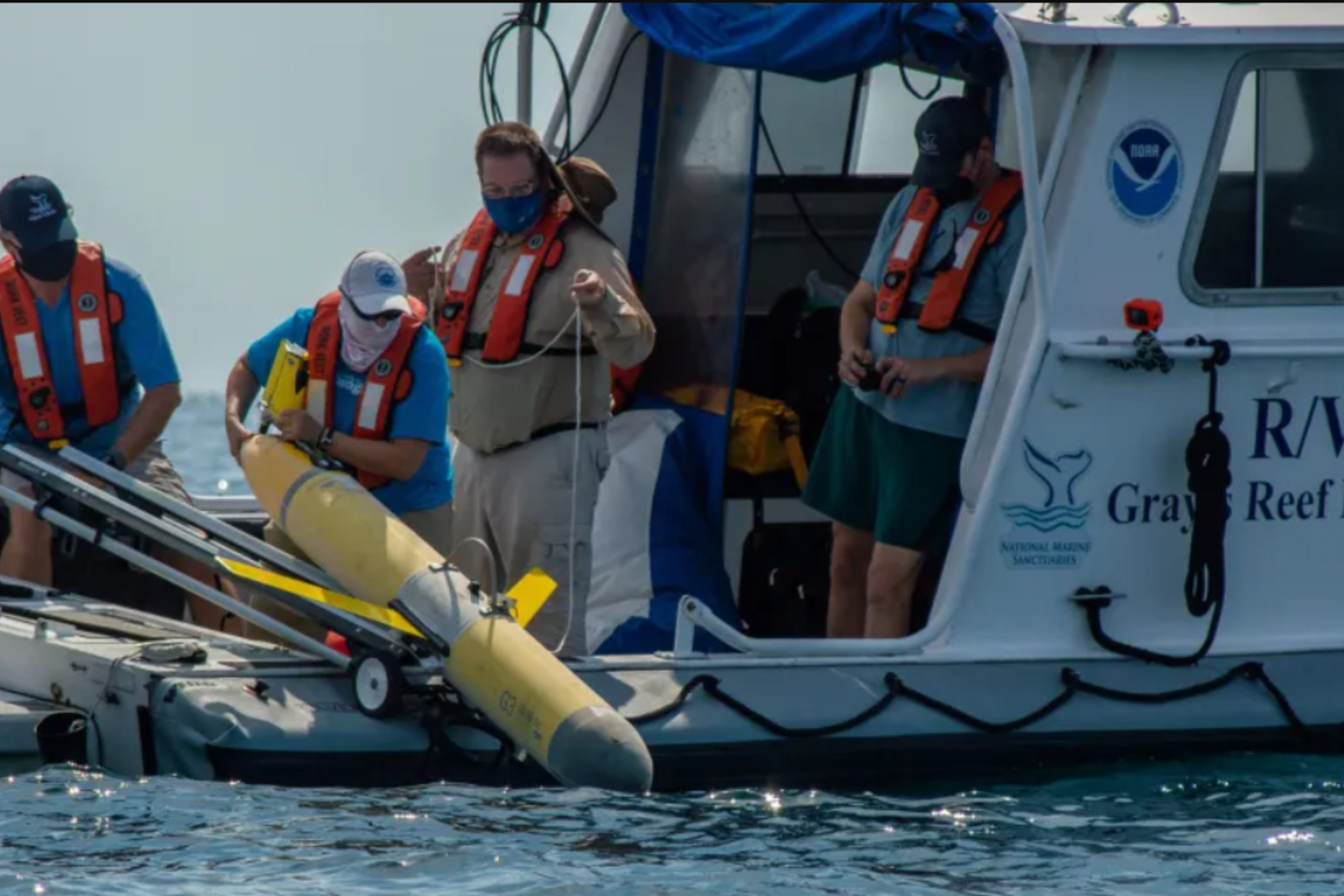 Technicians deploy “Franklin,” an autonomous underwater vehicle whose data is used to improve hurricane forecasts.