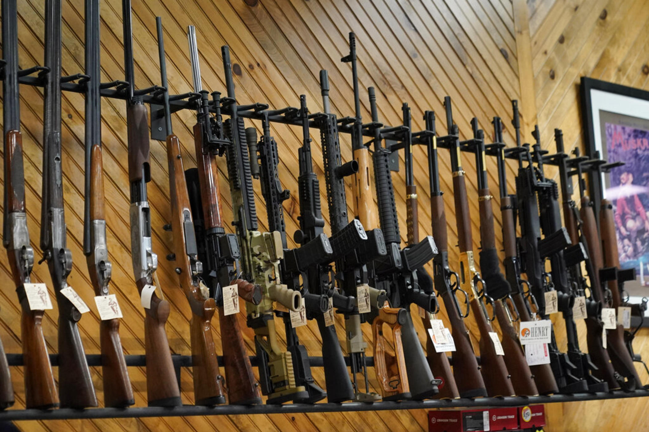 Various guns are displayed at a store on July 18, 2022, in Auburn, Maine. Most U.S. adults think gun violence is increasing nationwide and want to see gun laws made stricter. That's according to a new poll that finds broad public support for a variety of gun restrictions. The poll comes from the University of Chicago Harris School of Public Policy and The Associated Press-NORC Center for Public Affairs Research.