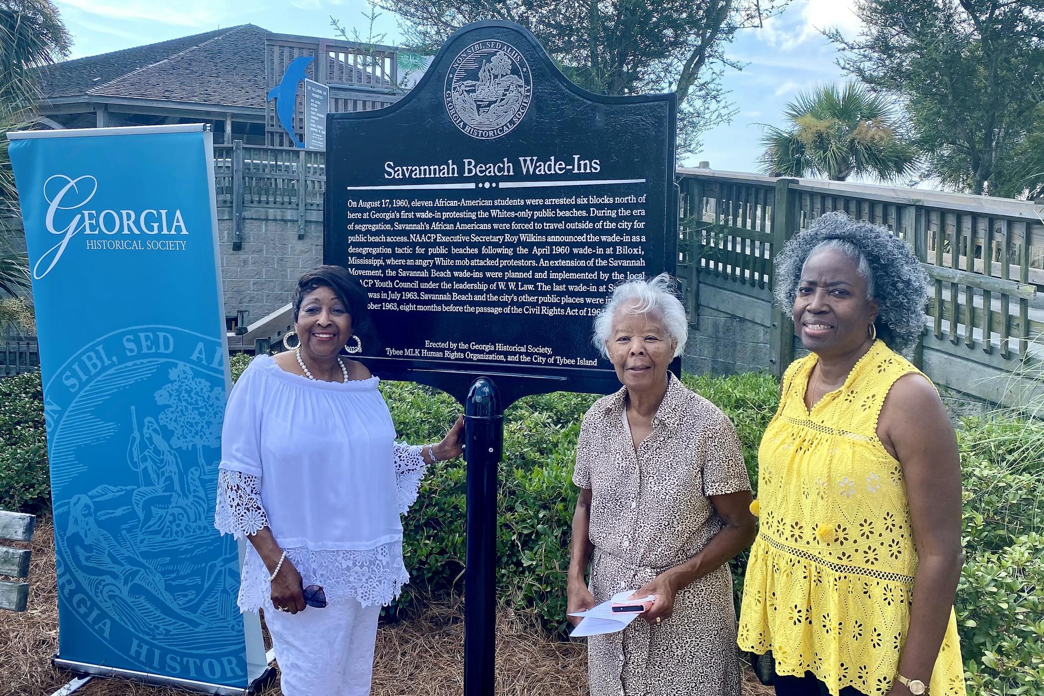 Georgia State Rep. Edna Jackson, Evalena Hoskins, and Mary Gray pose next to a new historical marker on Tybee Island commemorating the Savannah Beach Wade-Ins of the early 1960s.