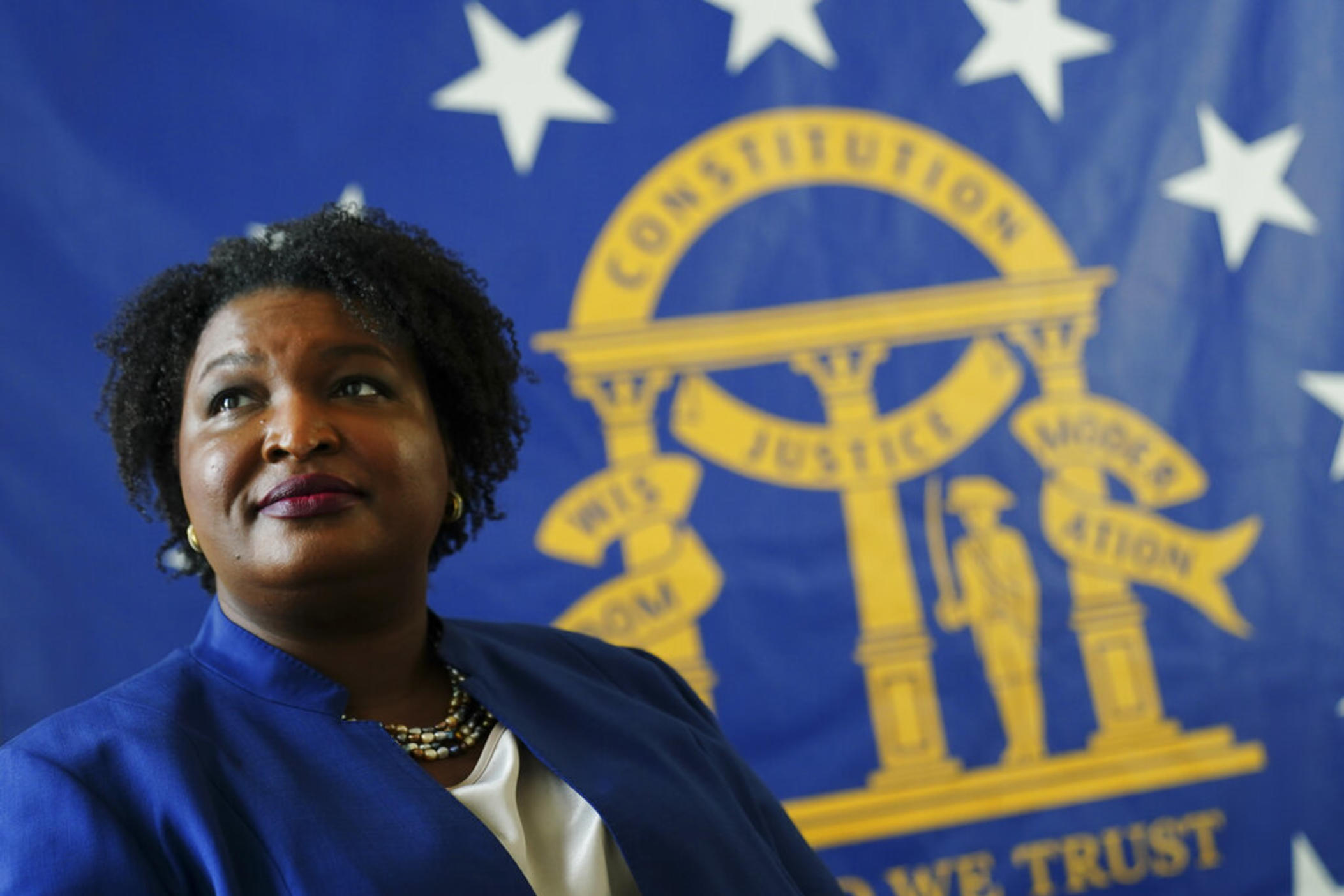 Democratic candidate for Georgia Governor Stacey Abrams poses for a portrait in front of the State Seal of Georgia Monday, Aug. 8, 2022, in Decatur, Ga.