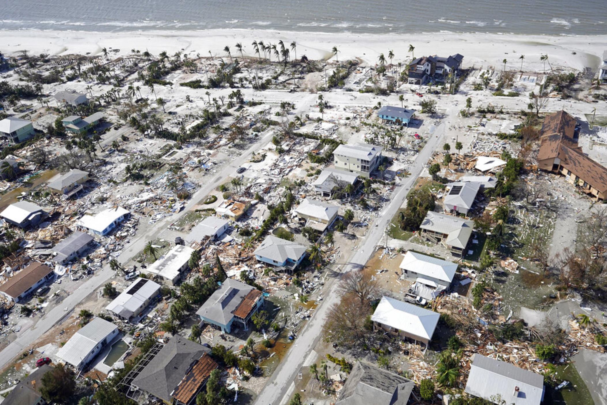 This aerial photo shows damaged homes and debris in the aftermath of Hurricane Ian, Thursday, Sept. 29, 2022, in Fort Myers, Fla. 