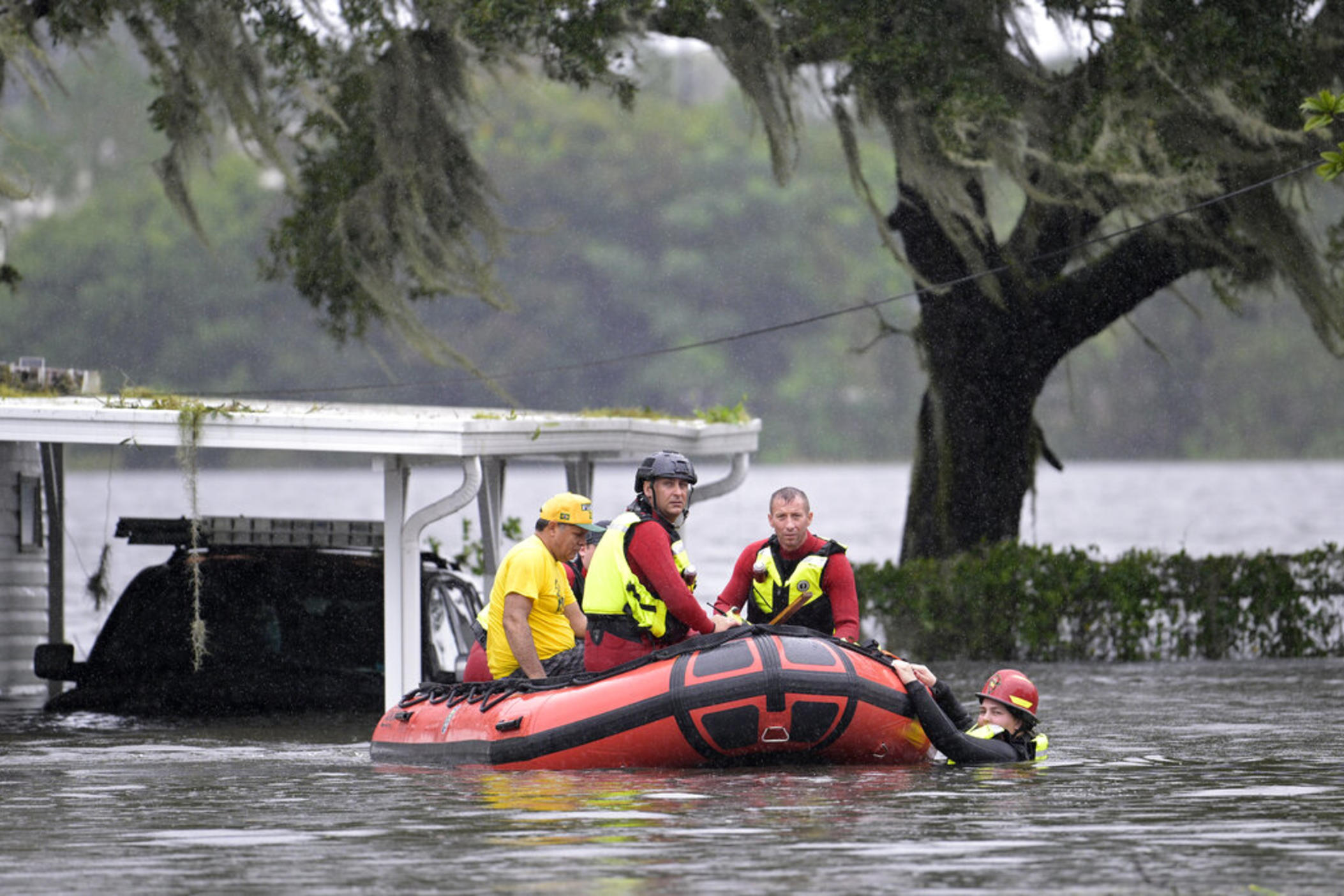First responders with Orange County Fire Rescue use an inflatable boat to rescue a resident from a home in the aftermath of Hurricane Ian, Thursday, Sept. 29, 2022, in Orlando, Fla.