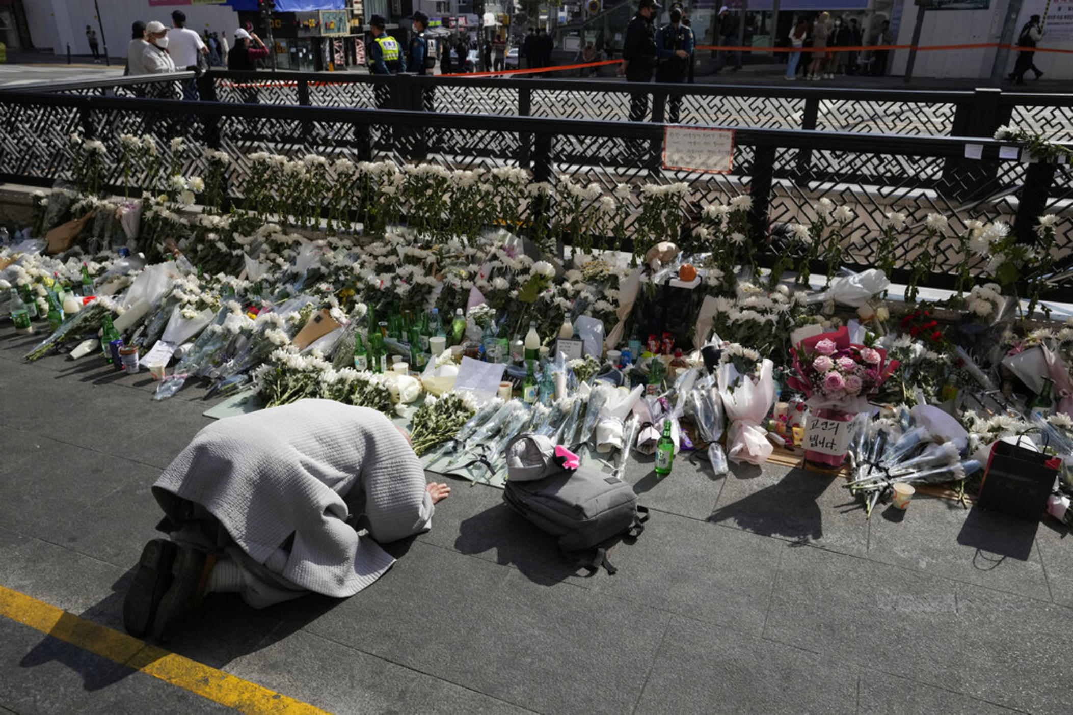 A Buddhist monk bows to pay tribute to victims of a deadly accident following Saturday night's Halloween festivities on the street near the scene in Seoul, South Korea, Monday, Oct. 31, 2022. Police are investigating what caused a crowd surge that killed more than 150 people during Halloween festivities in Seoul over the weekend in the country’s worst disasters in years. 