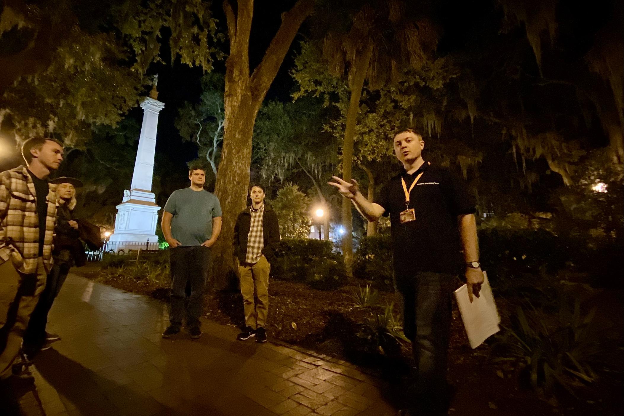 Brandon Carter leads his “Savannah Dark History Tour” in downtown's Monterey Square. The Casimir Pulaski Monument is in the background.