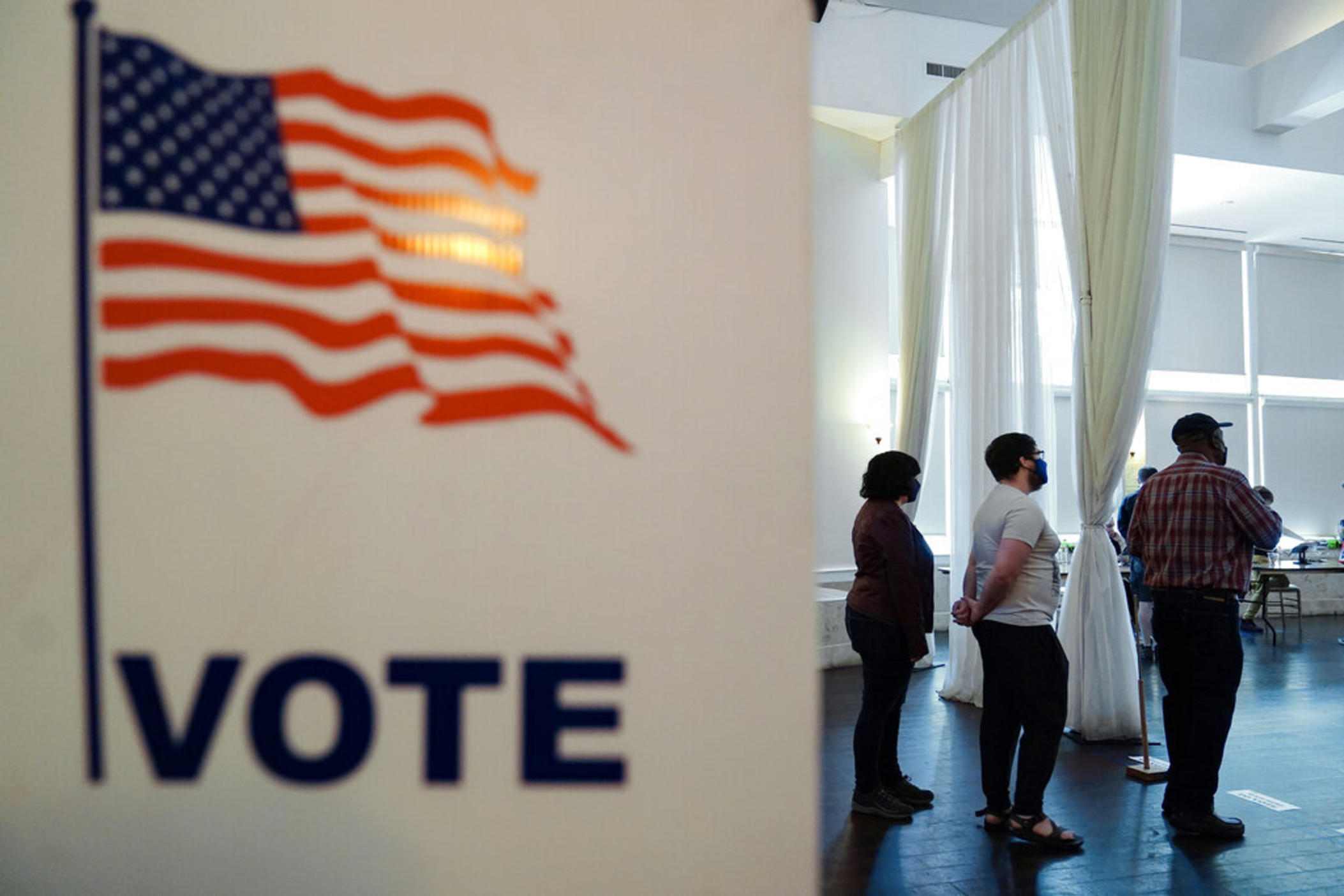 People wait in line to vote in the Georgia's primary election on Tuesday, May 24, 2022, in Atlanta.