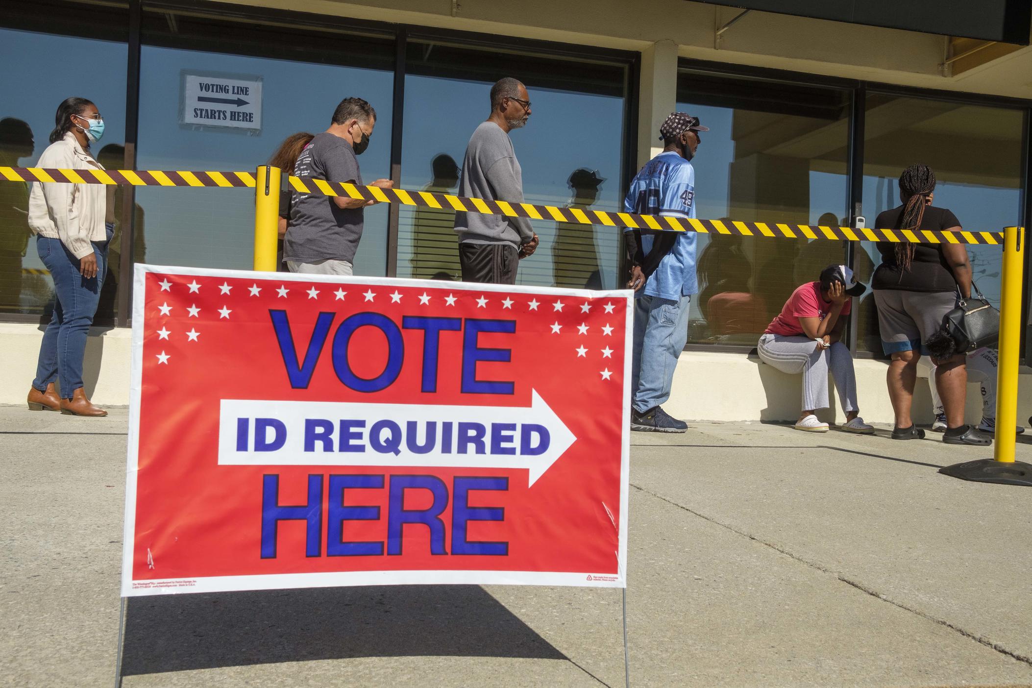 The line to vote at the board of elections in Macon, Ga., stretched around the corner from the front door and into a half-hour wait by around 1 p.m. on the final day of early voting, Nov. 4, 2022. 