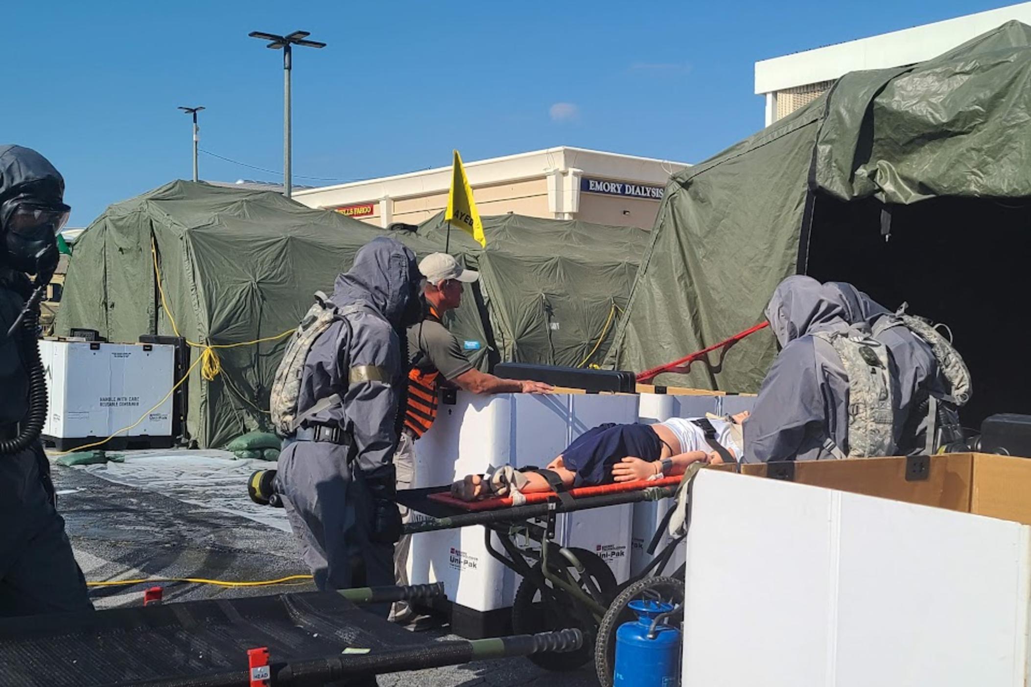 Military members and first responders learn how to decontaminate people and animals in the event of nuclear detonation at a training exercise November 4, 2022 in East Point, GA.