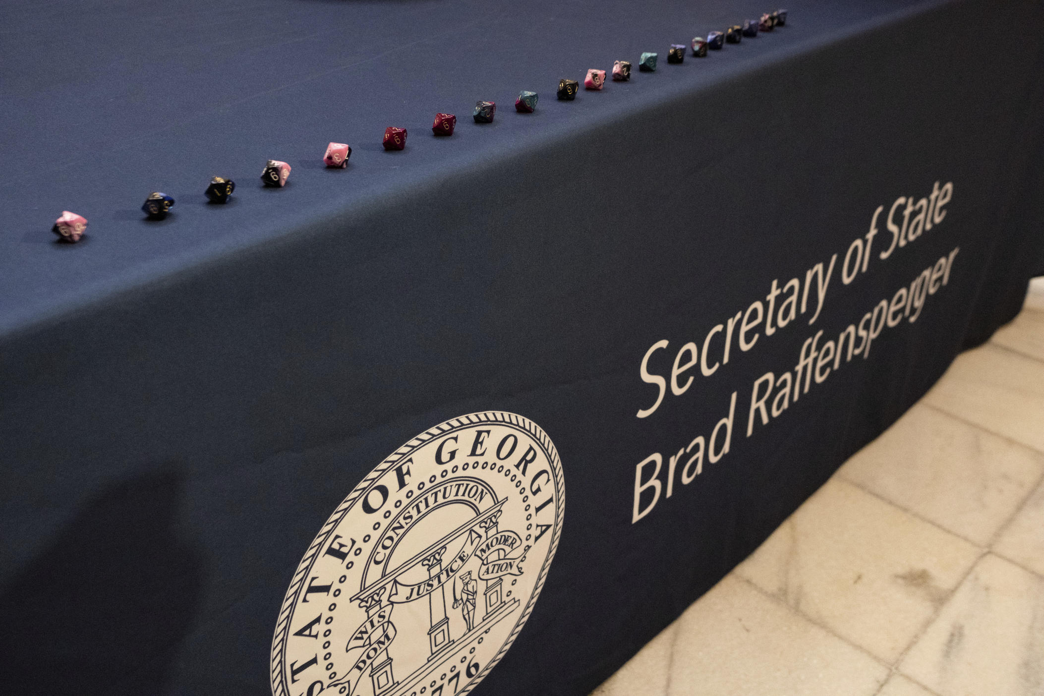 A row of 10-sided dice sit on the table after being used as part of process to randomly determine which batches of ballots to audit for a state-wide risk limiting audit of the 2022 general election during a press conference Wednesday, Nov. 16, 2022, at the Georgia Capitol in Atlanta.