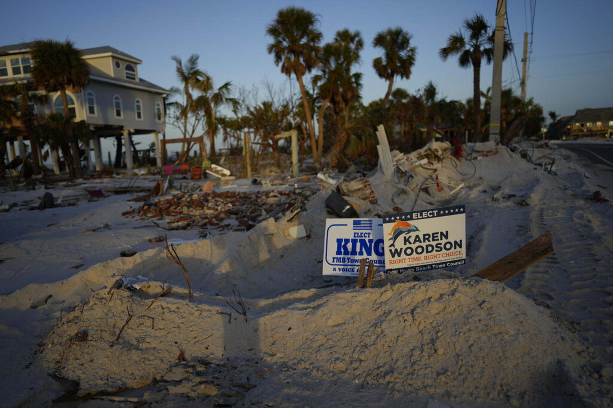 Signs promoting candidates for Fort Myers Beach town council sit along a roadside on Estero Island, which was heavily damaged in September's Hurricane Ian, in Fort Myers Beach, Fla, Tuesday, Nov. 8, 2022. After the area was devastated and thousands were left displaced by Hurricane Ian, Lee County extended their early voting period and permitted voters on Election Day to cast their ballot in any of the dozen open polling places. 