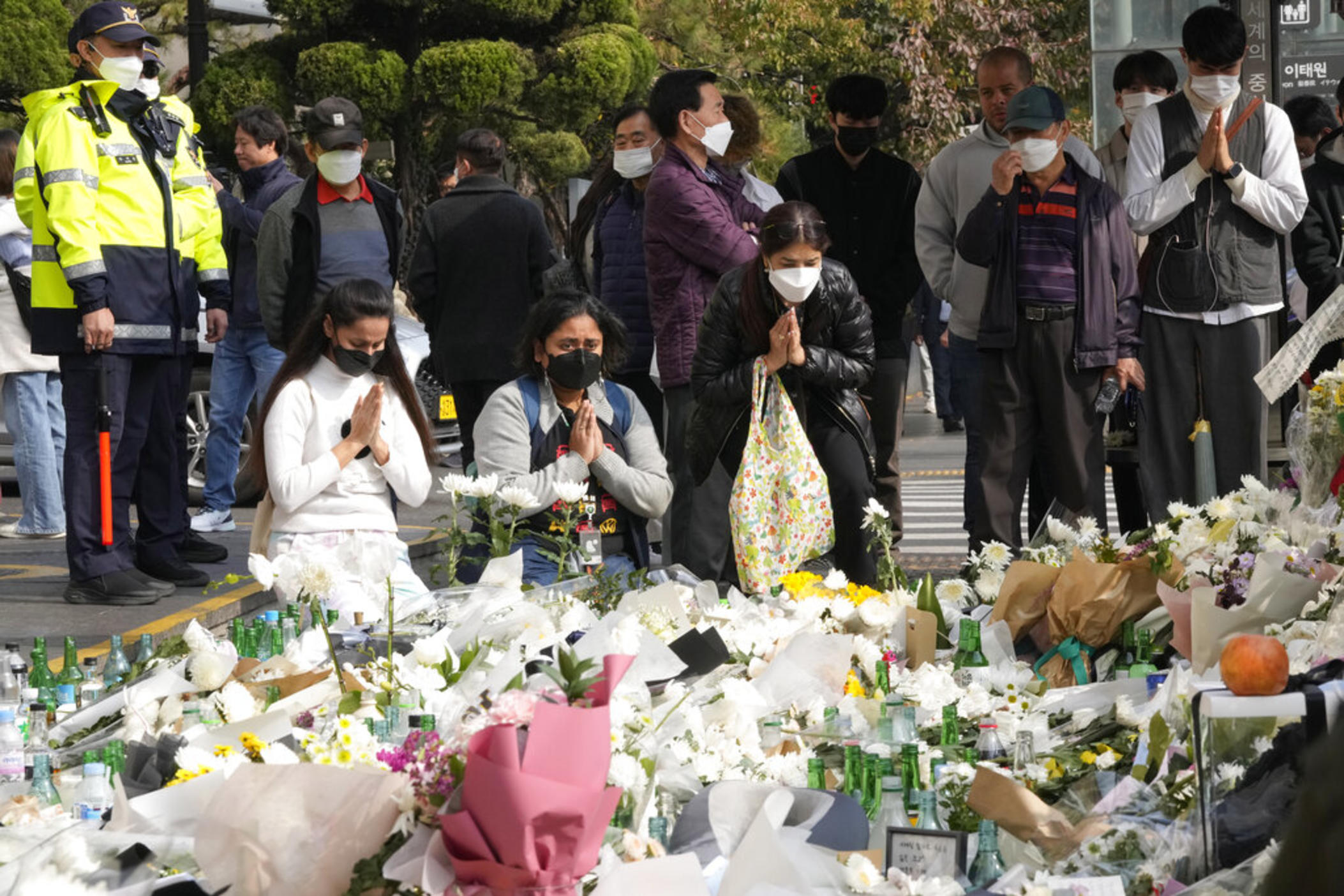  People pray for victims of a deadly accident following Saturday night's Halloween festivities on a street near the scene in Seoul, South Korea, Tuesday, Nov. 1, 2022. An Australian survivor of a crowd crush that killed more than 150 partygoers in the South Korean capital of Seoul blamed the huge loss of life on officials’ failure to employ effective crowd controls despite anticipating a massive turnout for the Halloween celebrations.