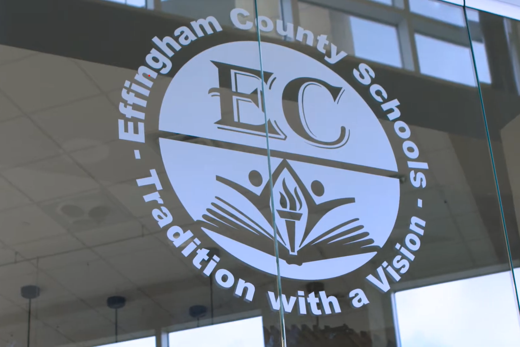 The Effingham County School District logo is displayed on a clear glass wall inside a building.