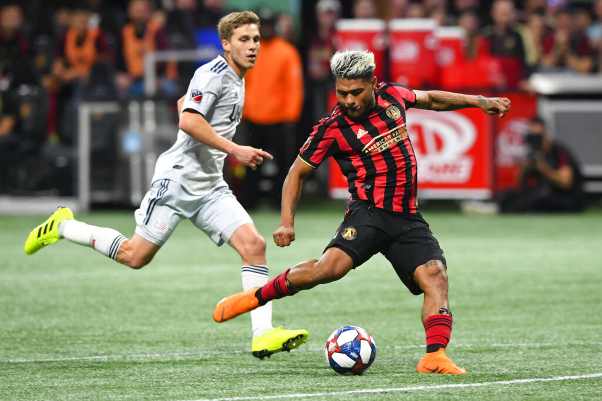 Atlanta United forward Josef Martinez (7) kicks a shot on goal as New England Revolution midfielder Scott Caldwell follows during round one of an MLS Cup playoff soccer game Saturday, Oct. 19, 2019, in Atlanta. Josef Martinez, the 2018 MVP and centerpiece of Atlanta United's rise to prominence in Major League Soccer, was released by the team on Wednesday, Jan. 18, 2023, and quickly signed a deal with Inter Miami.