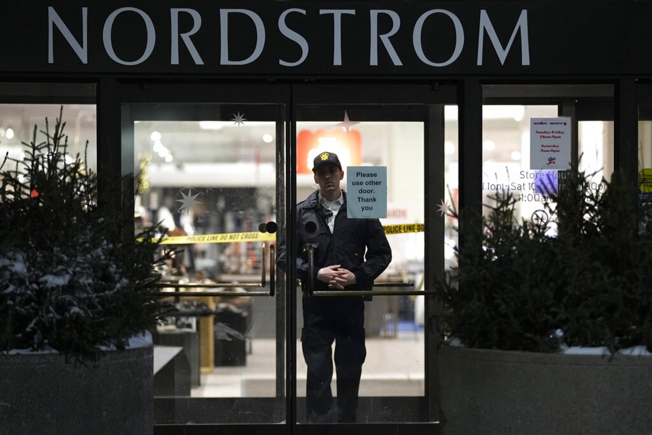 An officer stands inside Nordstrom at Mall of America after a shooting, Friday, Dec. 23, 2022, in Bloomington, Minn. A suspect wanted in connection with the fatal shooting at the mall in December was arrested in Georgia on Tuesday, Jan. 17, 2023. 