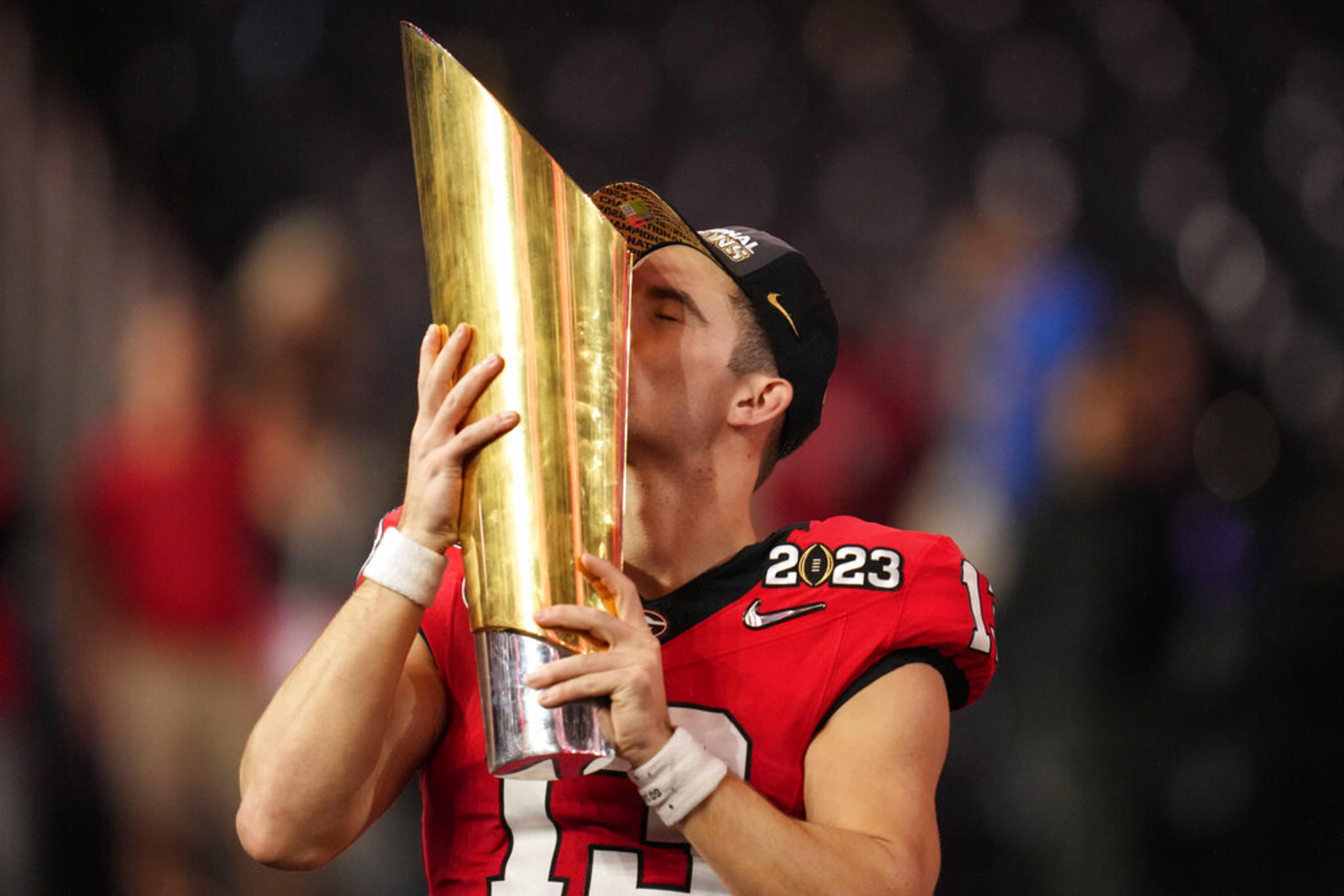 Georgia quarterback Stetson Bennett (13) kisses the championship trophy after the national championship NCAA College Football Playoff game against TCU, Monday, Jan. 9, 2023, in Inglewood, Calif. Georgia won 65-7.