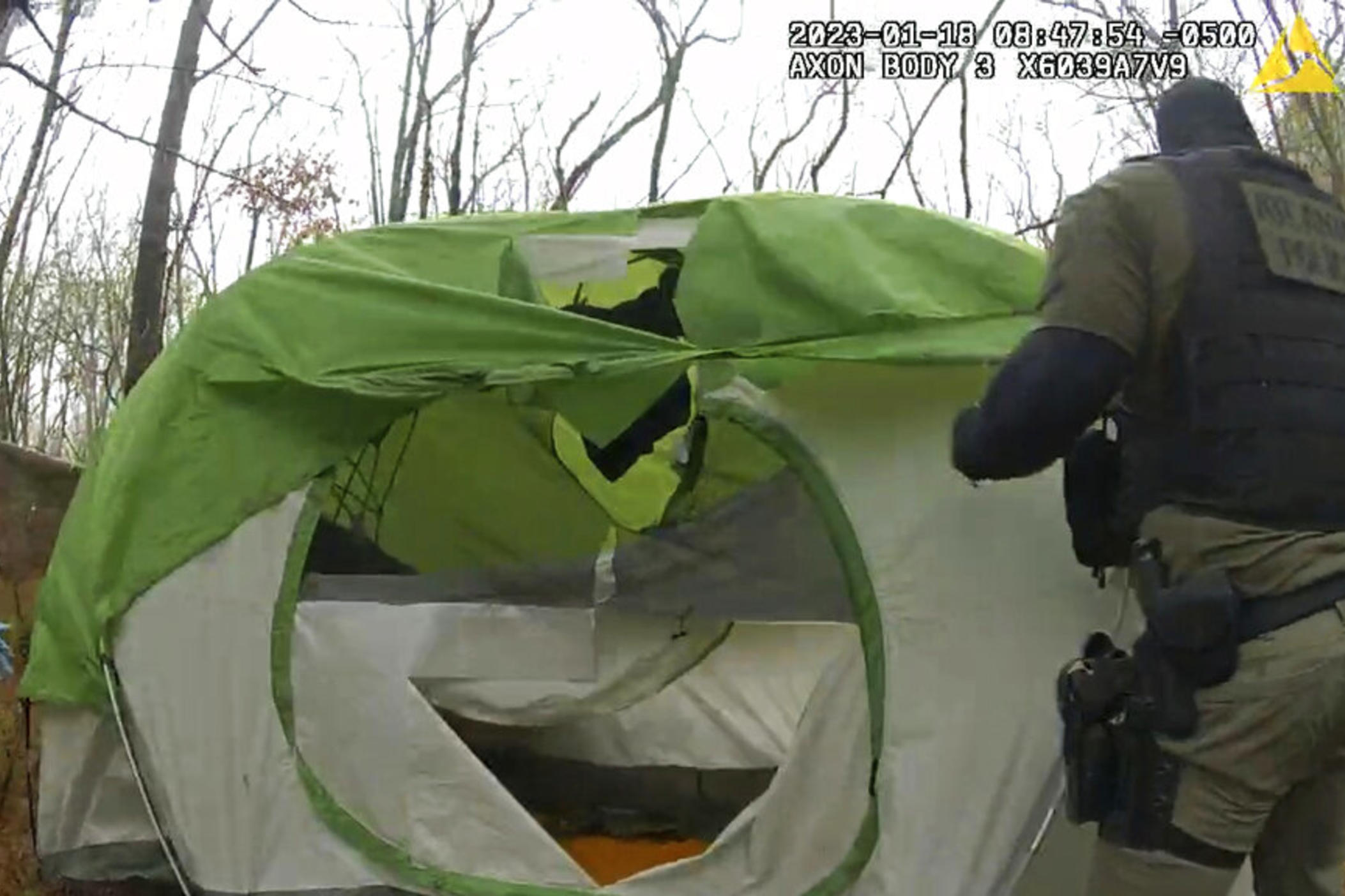 In this image taken from body cam video released by the Atlanta Police Department, officers remove and shred items from empty tent near the future site of the City of Atlanta’s Public Safety Training Center on Jan. 18, 2023, near Atlanta, Ga. Some activists — self-described “forest defenders” — began moving into the forest in protest. 