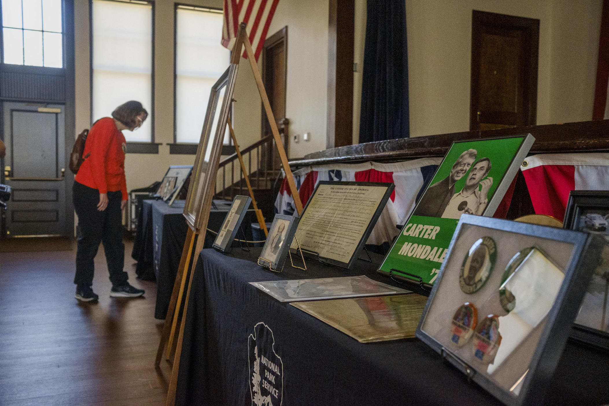 Rebecca Davenport of Columbus, Ga looks at presidential memorabilia on display for the Presidents' Day observance at the Jimmy Carter National Historic Site in Plains, Ga. Monday. Davenport wore her own historic piece: a pin from Carter's 1977 presidential inauguration.