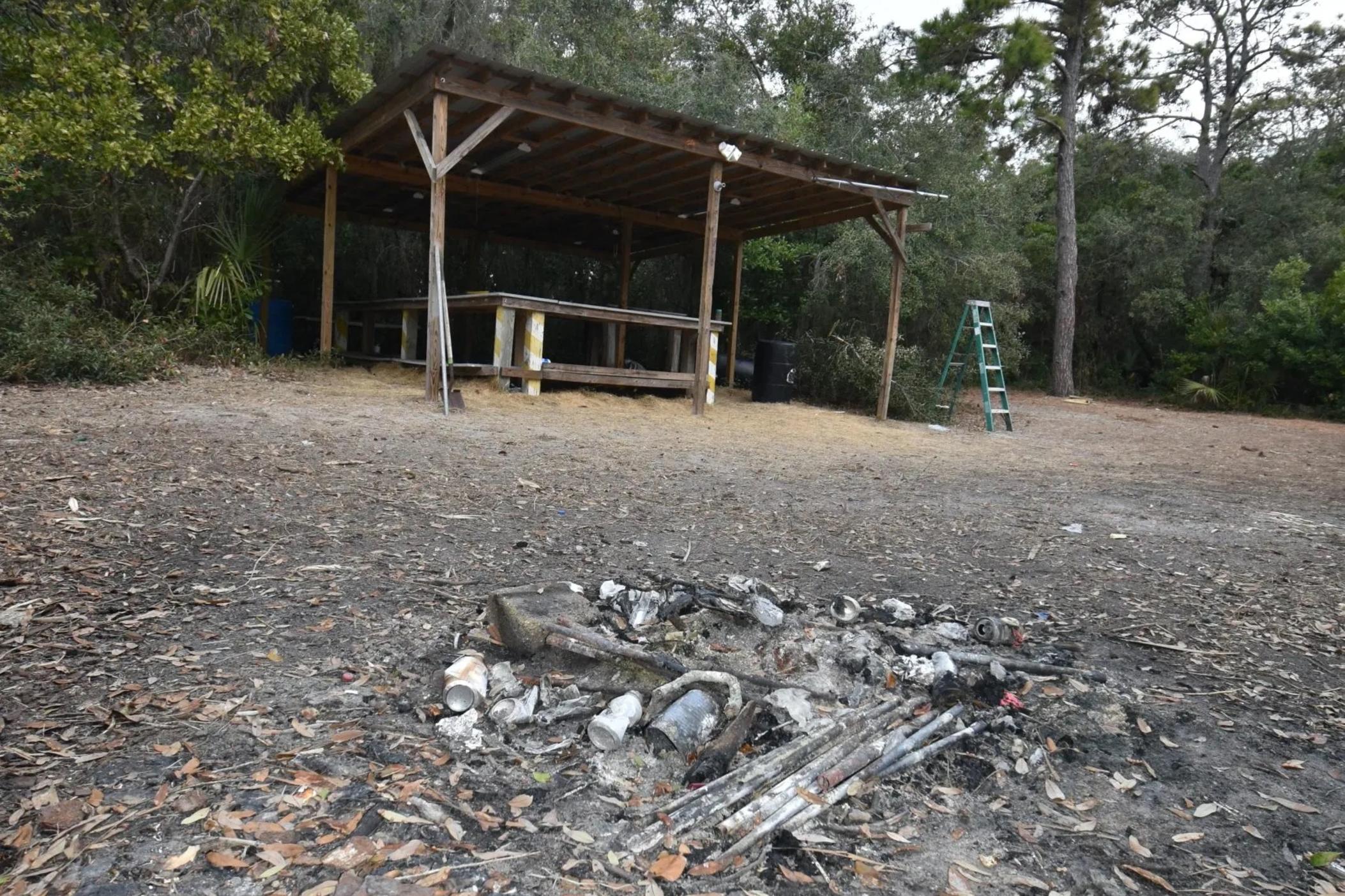 An old campfire sits in front of an illegal kitchen structure on the Twin Palms area of Little Tybee in January. Credit: Stewart Dohrman