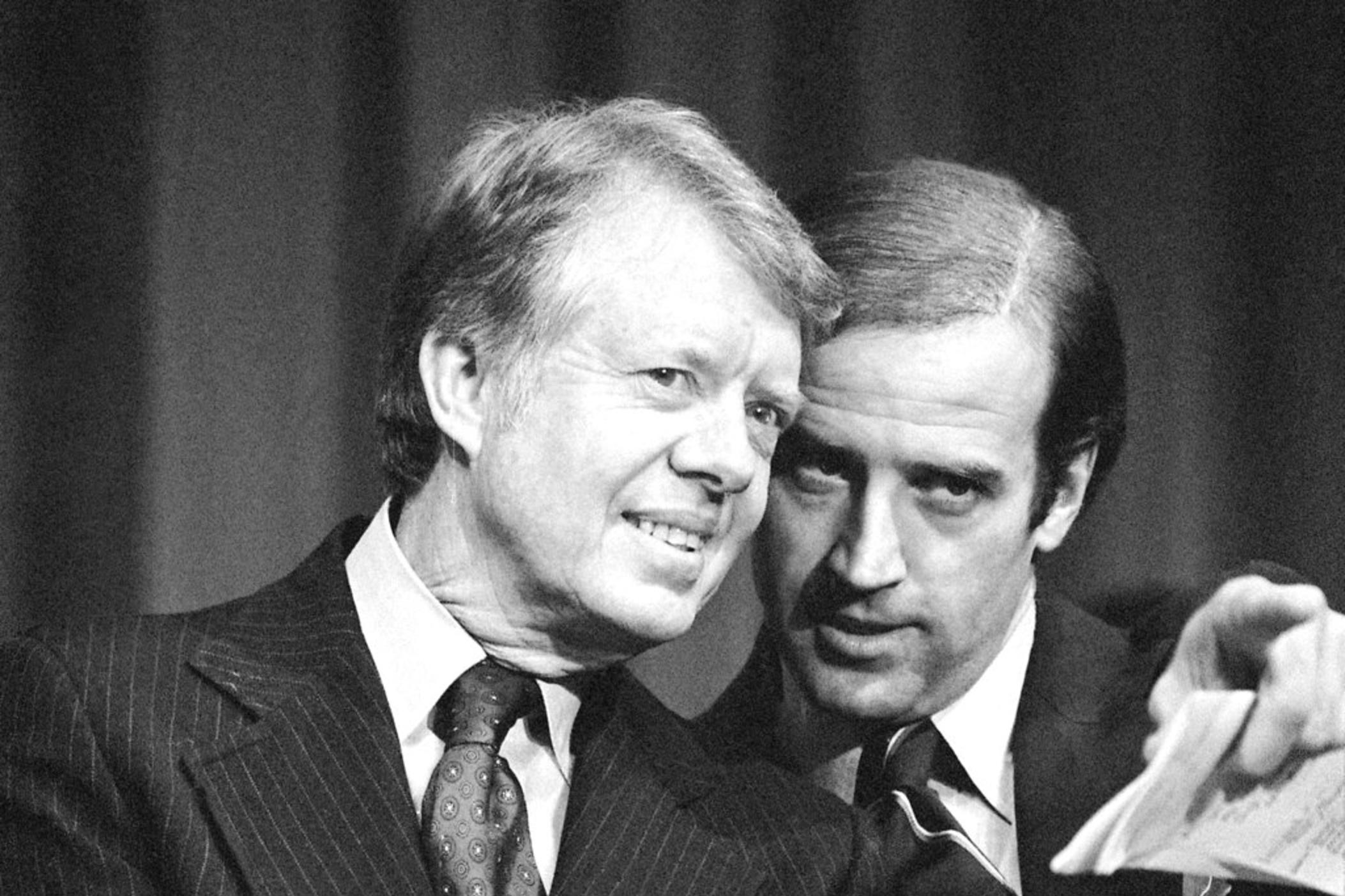 In this Feb. 20, 1978, file photo, President Jimmy Carter listens to Sen. Joseph R. Biden, D-Del., as they wait to speak at fund raising reception at Padua Academy in Wilmington, Del. 