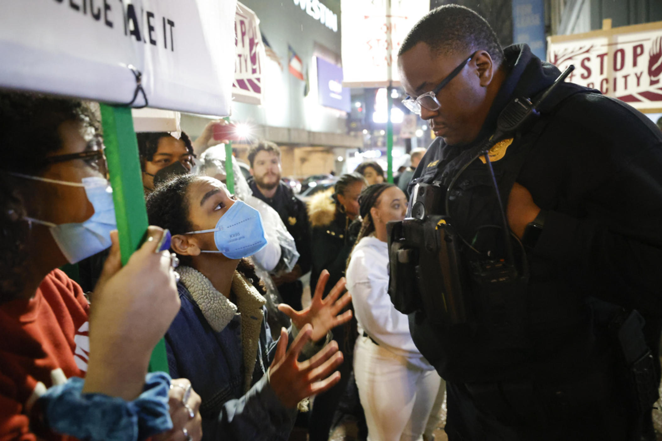 Demonstrators confront an Atlanta police officer during a protest over plans to build a new police training center, Thursday, March 9, 2023, in Atlanta.
