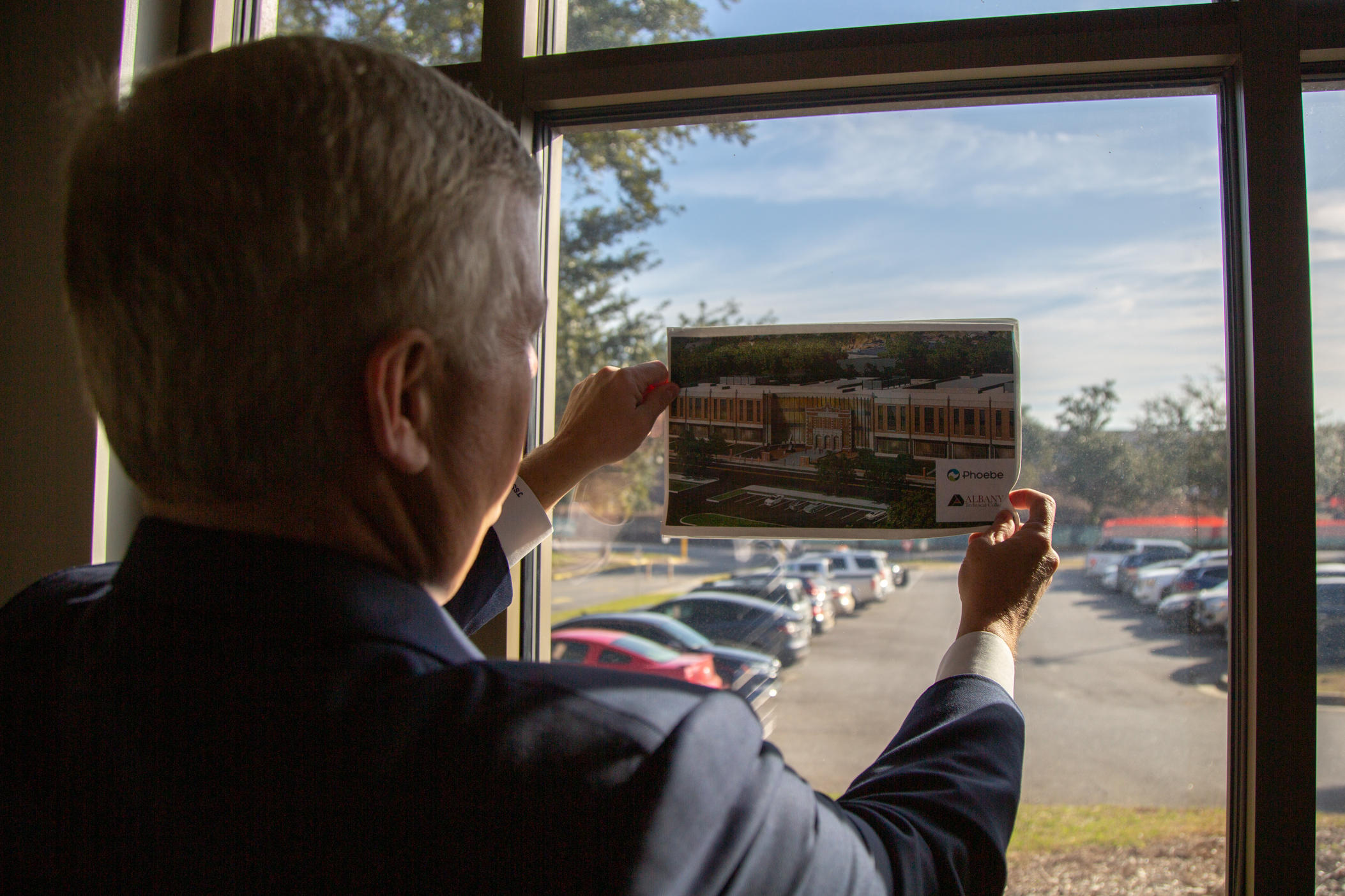 President and CEO of the Phoebe Putney Health System, Scott Steiner, holds a mock-up of the new development against his office window. He hopes the partnership will encourage more nursing students to stay in Albany, G.a., and grow the workforce both at Phoebe Putney and in the region.
