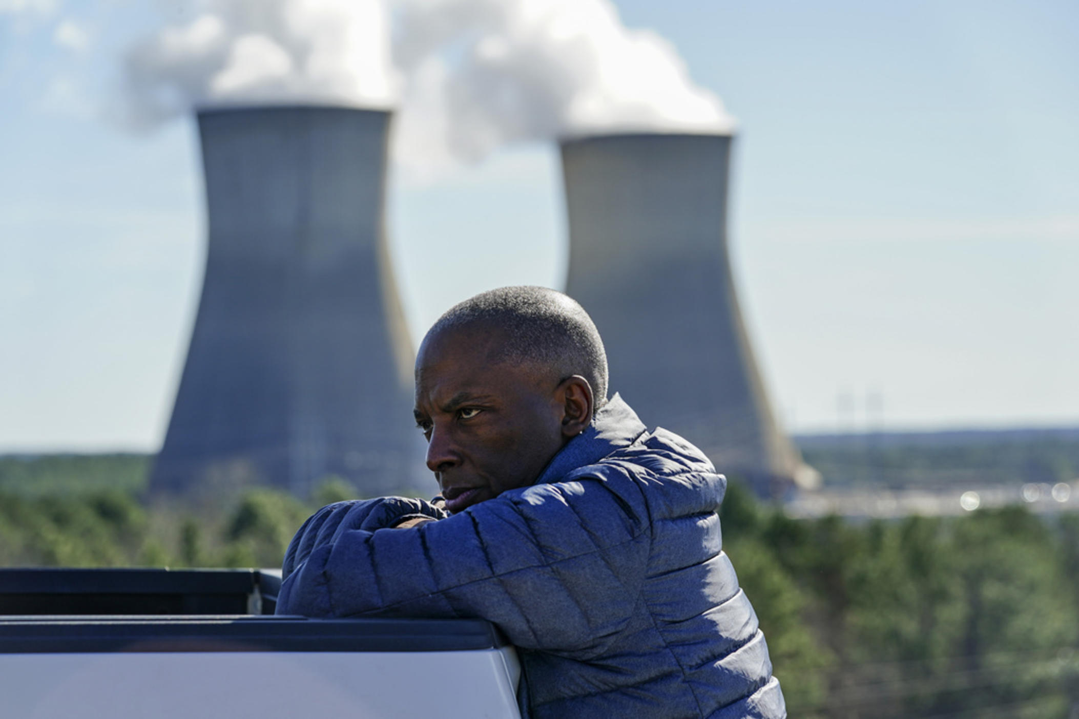 Georgia Power Co. CEO Chris Womack rests on a company truck as he talks with members of his team at Plant Vogtle nuclear power plant on Jan. 20, 2023, in Waynesboro, Ga. Despite years of delays and billions in overruns, Womack, now CEO of parent Southern Co., says the two new reactors at the site are “absolutely” a success because they will provide reliable power and cheap fuel to the utility’s 2.7 million customers for decades.